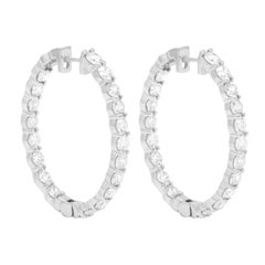 Diana M.14 kt white gold, 1.50" inside-out hoop earrings adorned with 8.12 cts