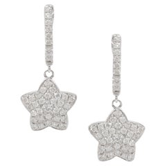 Diana M.18 kt white gold diamond huggie earrings  with a star design 