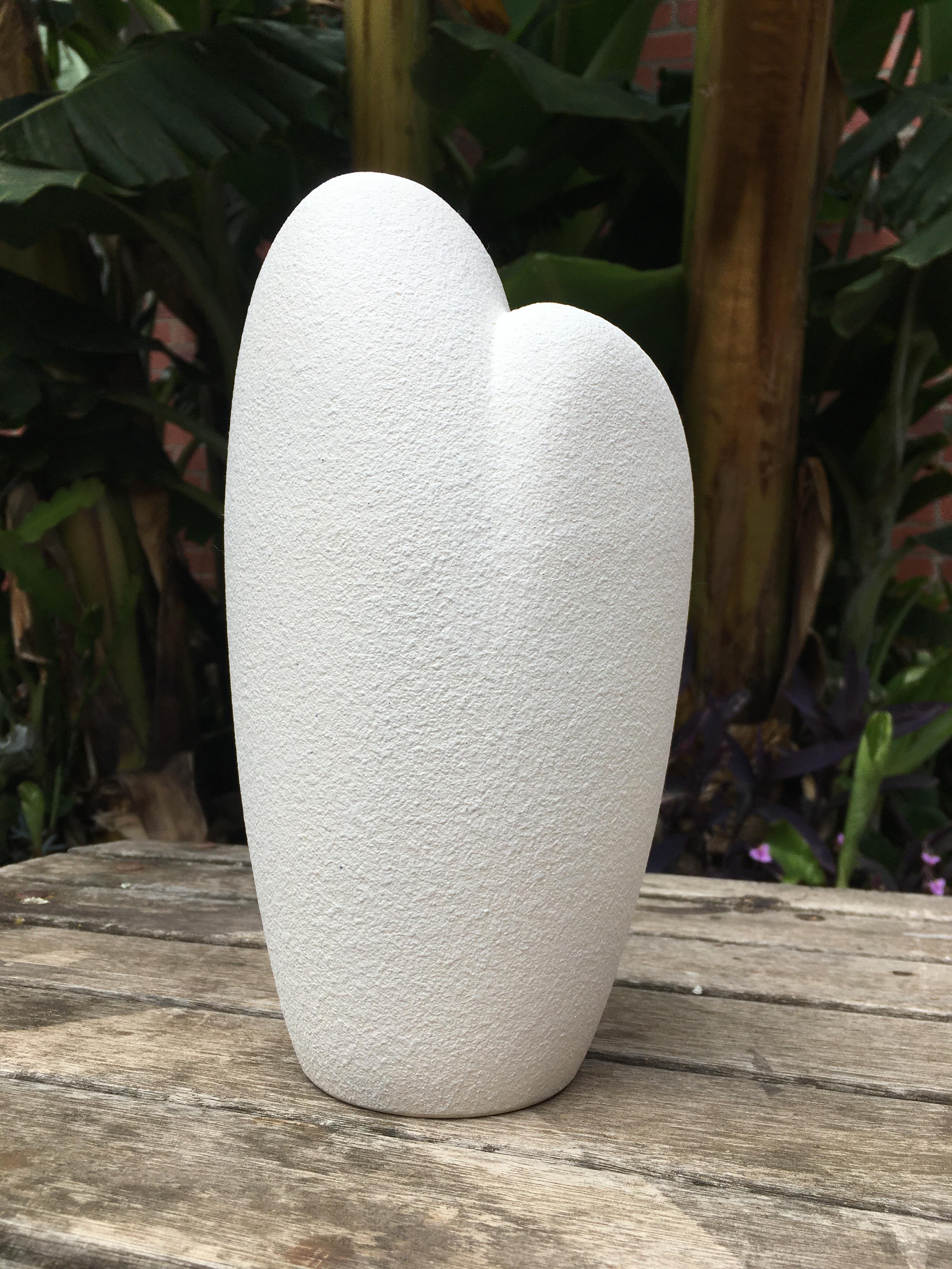 A Diana pottery vase with spackle texture white outer and butter yellow gloss interior. This slipware vase is a beautiful example of Australian midcentury pottery. The biomorphic form and colour/texture combination make this a perfect example of