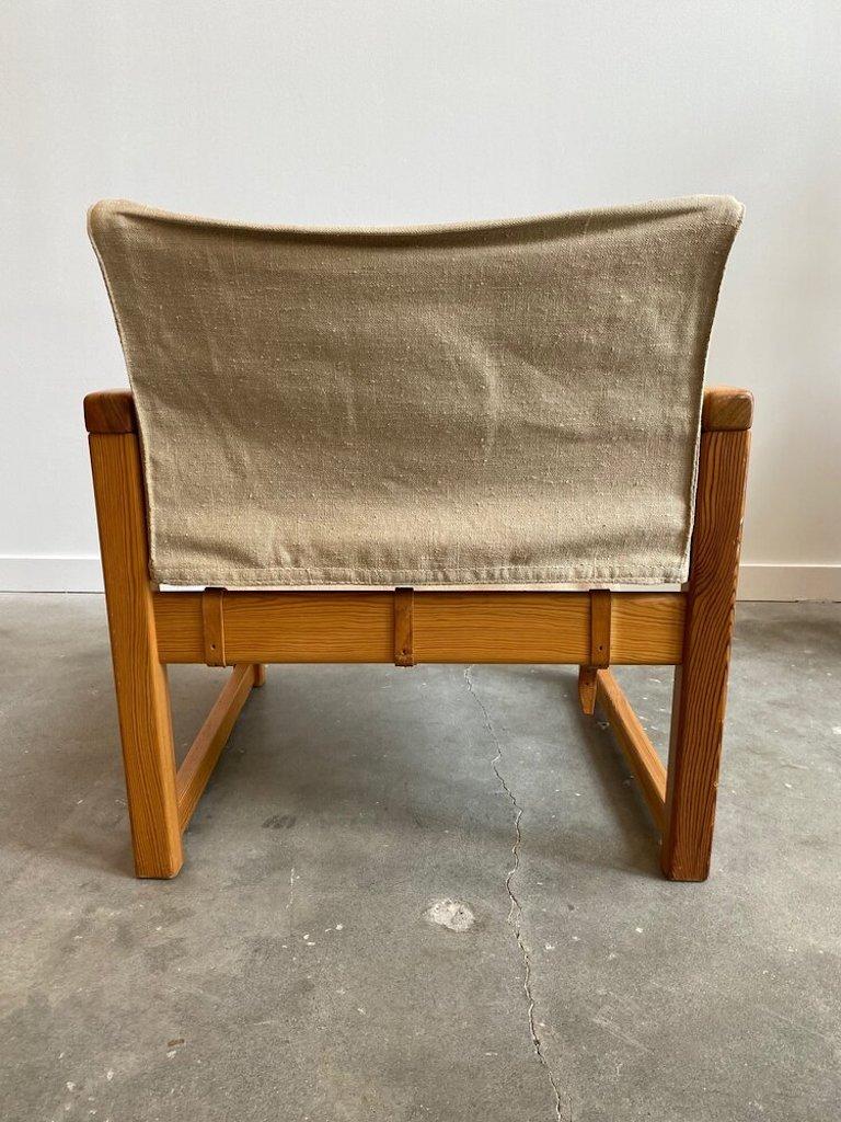 Karin Mobring’s “Diana” Sling chair manufactured by Ikea in 1972 in Sweden. It is made of dark stained pine and covered with a cotton canvas fabric attached by three leather straps.