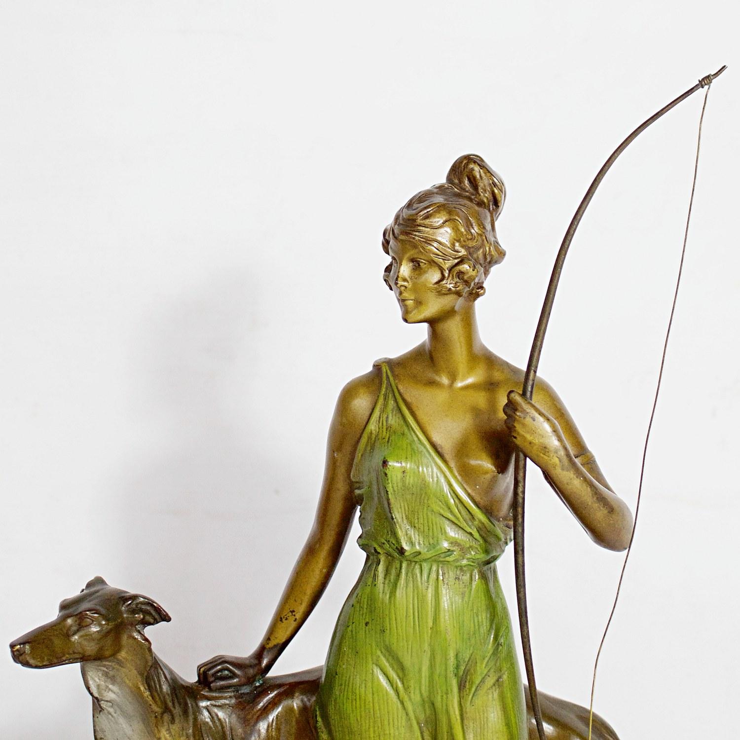 'Diana the Huntress' an Art Deco bronze sculpture by Bruno Zach depicting Diana huntress on the hunt with her loyal companion at her side. Green patinated dress and original patination. Set over a marble base. Signed 'Zach' to bronze.

Literature: