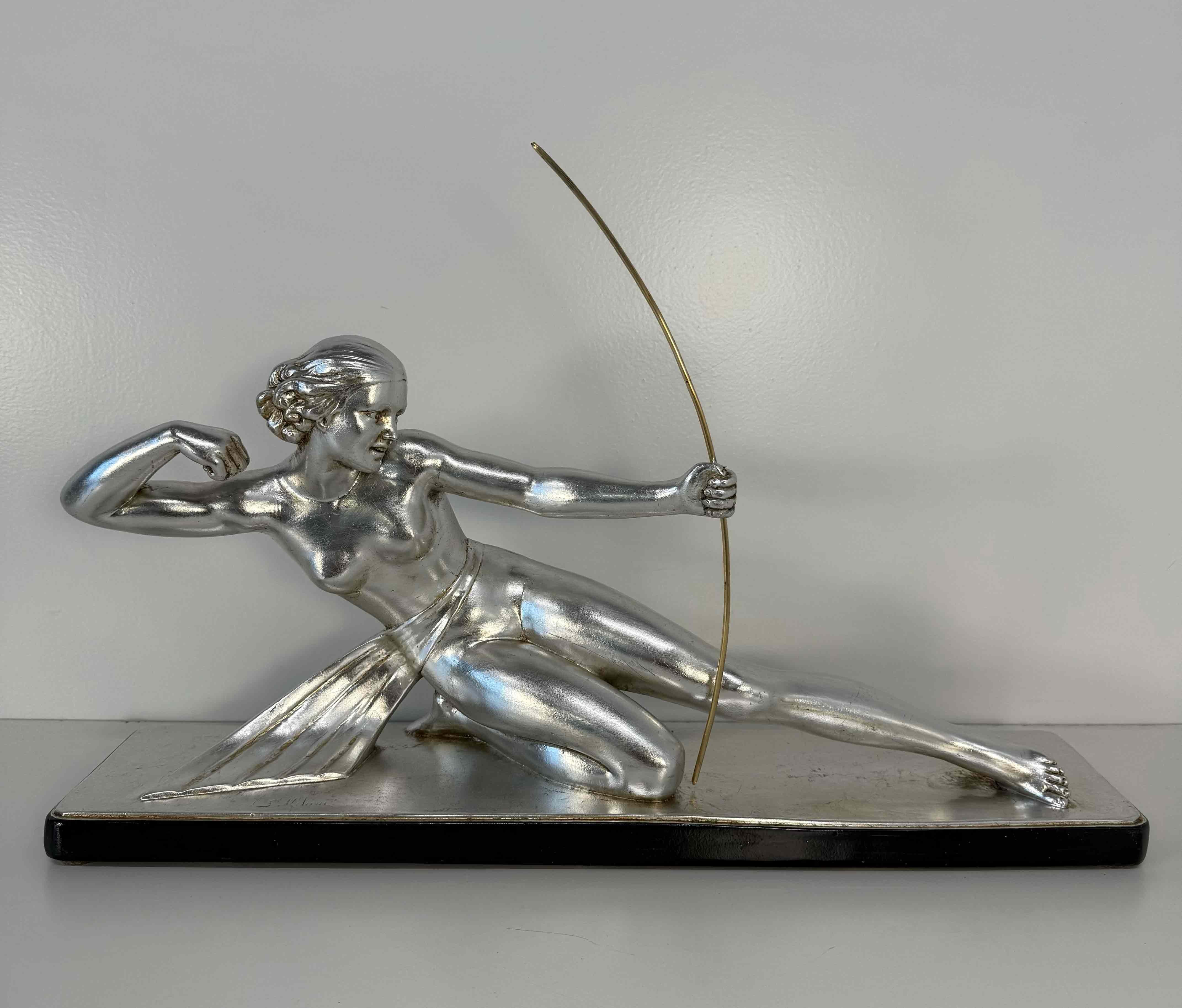 Elegant Art Deco sculpture depicting Diana the Huntress with a bow, created in the 1930s by Italian sculptor Salvatore Melani. The figure is crafted from plaster and finished with silver leaf, while the bow is delicately fashioned from brass. It