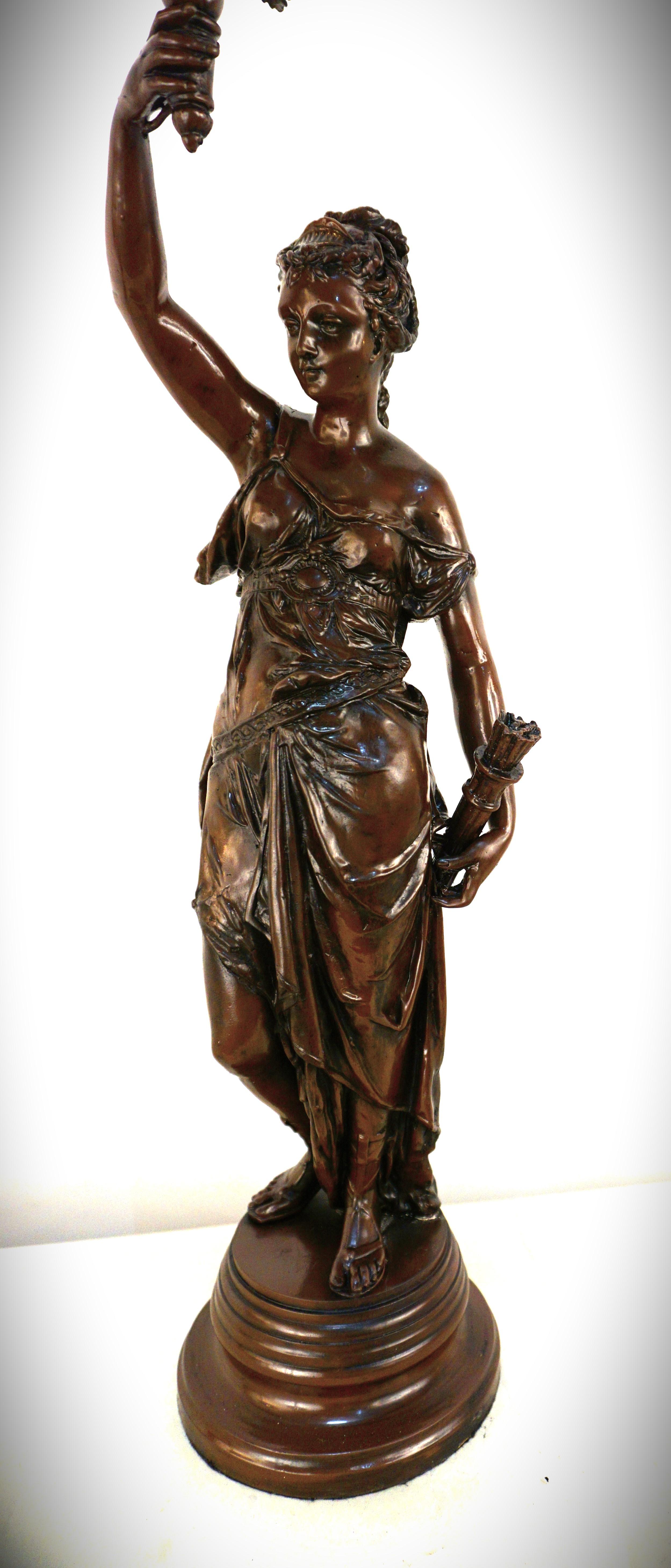 Bronze Diane the Hunter one hand over the arrow and other holding the torchlight withe glass flame.