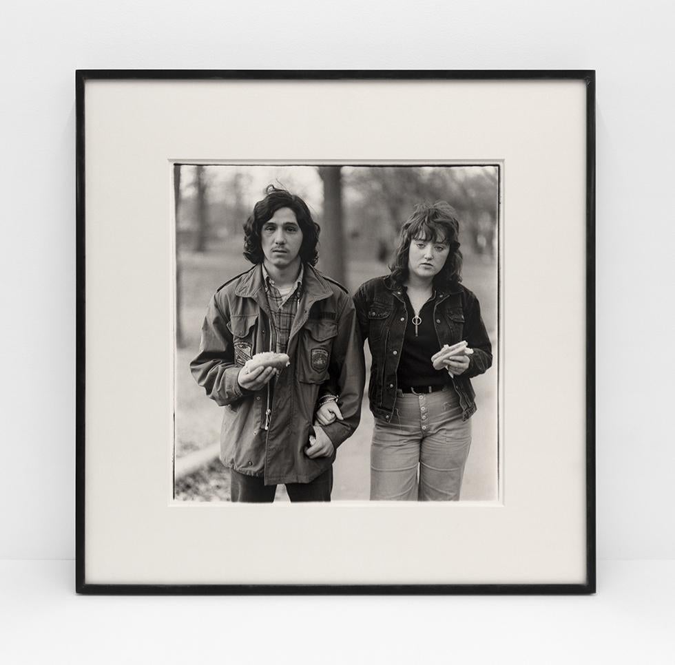 A young man and his girlfriend with hot dogs in the park, N.Y.C. 1971 - Photograph by Diane Arbus