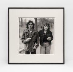 A young man and his girlfriend with hot dogs in the park, N.Y.C. 1971