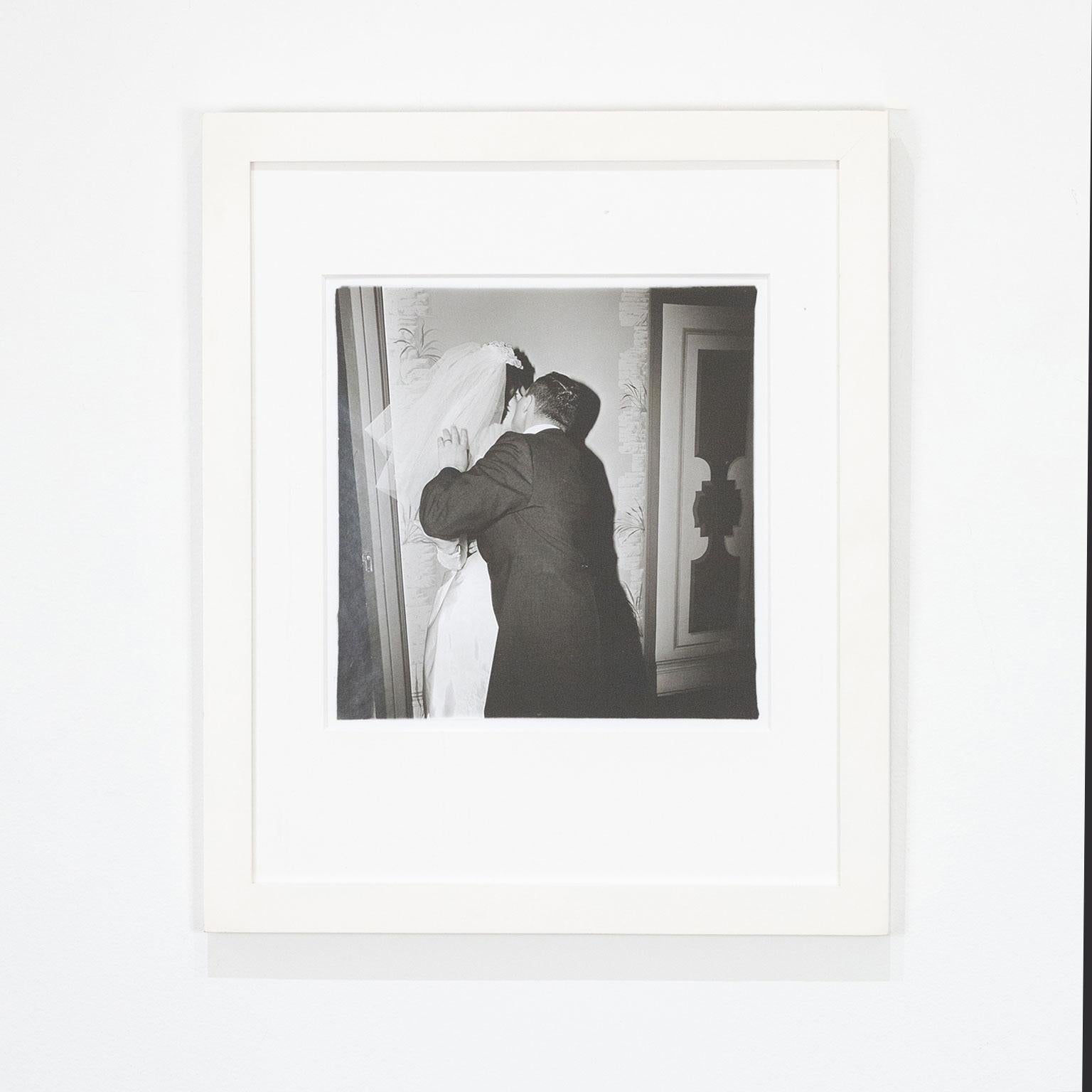 Diane Arbus Black and White Photograph - Groom Kissing His Bride