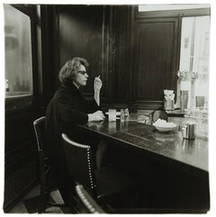 Woman at a counter smoking, N.Y.C. 1962