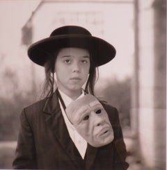 Photographic Portrait Young Hasidic Boy w/ Mask in the style of Diane Arbus