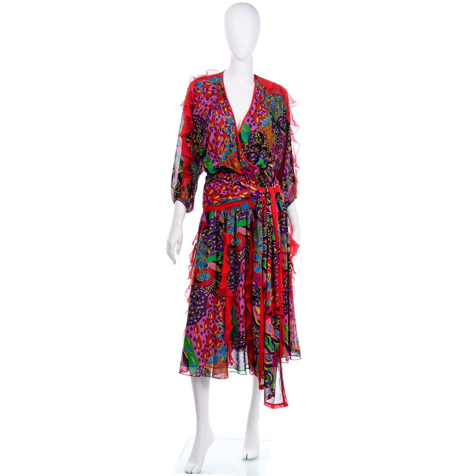 This is a fun bold and colorful dress designed by Diane Freis in the 1980's. The multi colored abstract pattern has unique swirls and teardrops accentuated with beads and sequins on the bodice, as well as sheer red ruffles that go down the arms as
