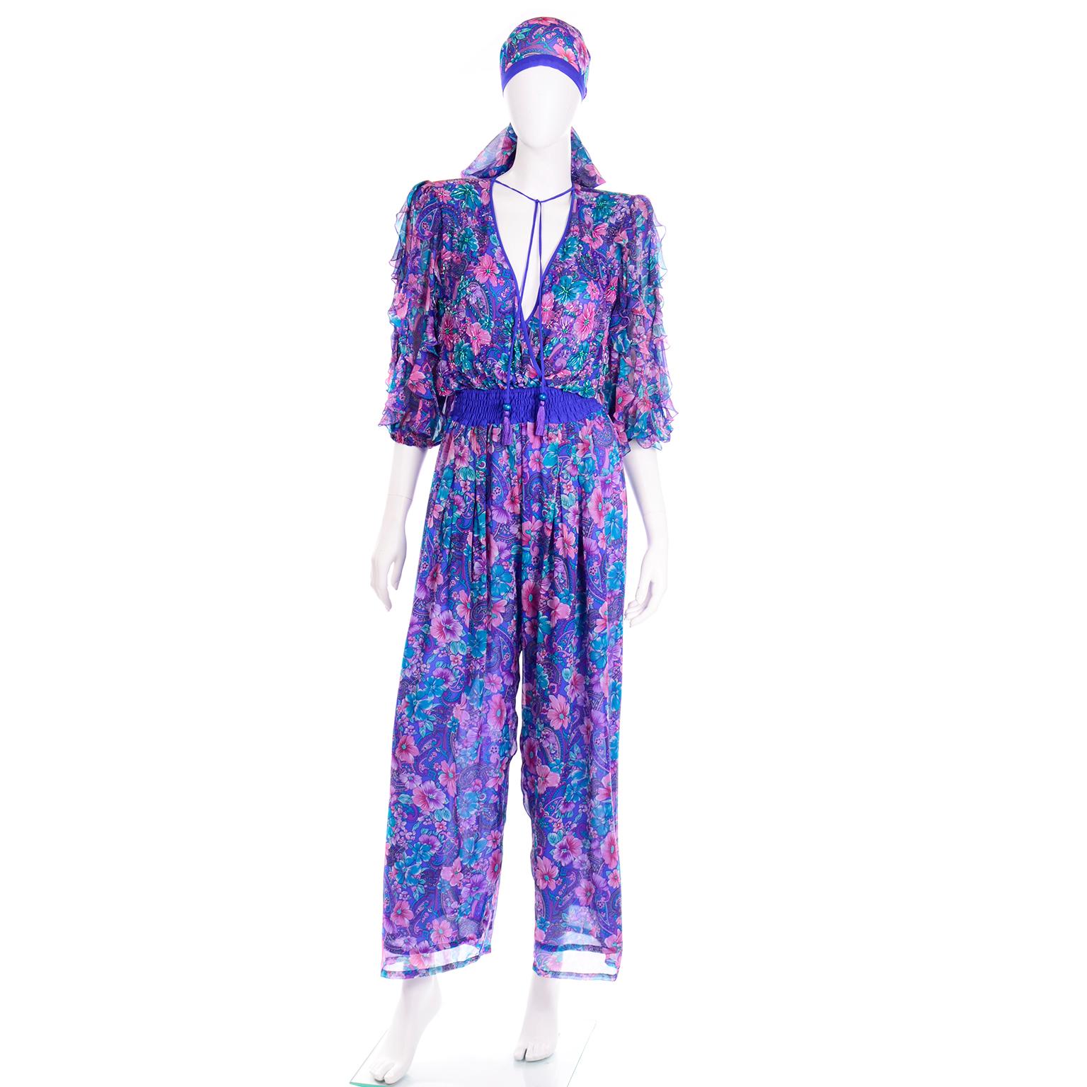 This Diane Freis floral silk and beaded jumpsuit is so gorgeous! This floral printed silk is in stunning tones of blue, teal, pink, purple, lavender, and white. We love that the front of the bust is beaded, making this a perfect Spring or Summer