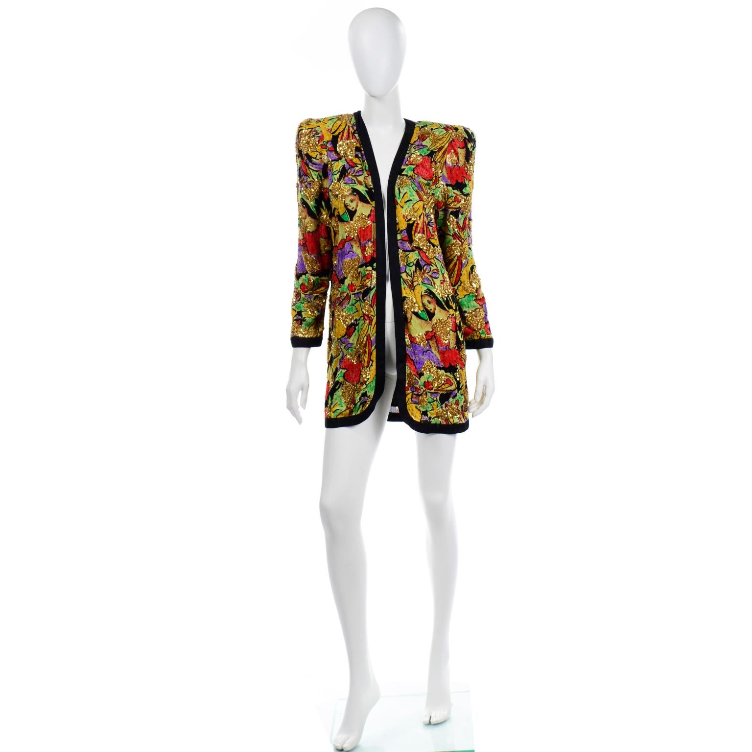 This 1980's vintage novelty face print Diane Freis silk open front jacket is in fun shades of red, green, yellow and purple and it has black silk patterned lining and trim. The jacket is beaded with multi colored beads and embellished with sequins. 