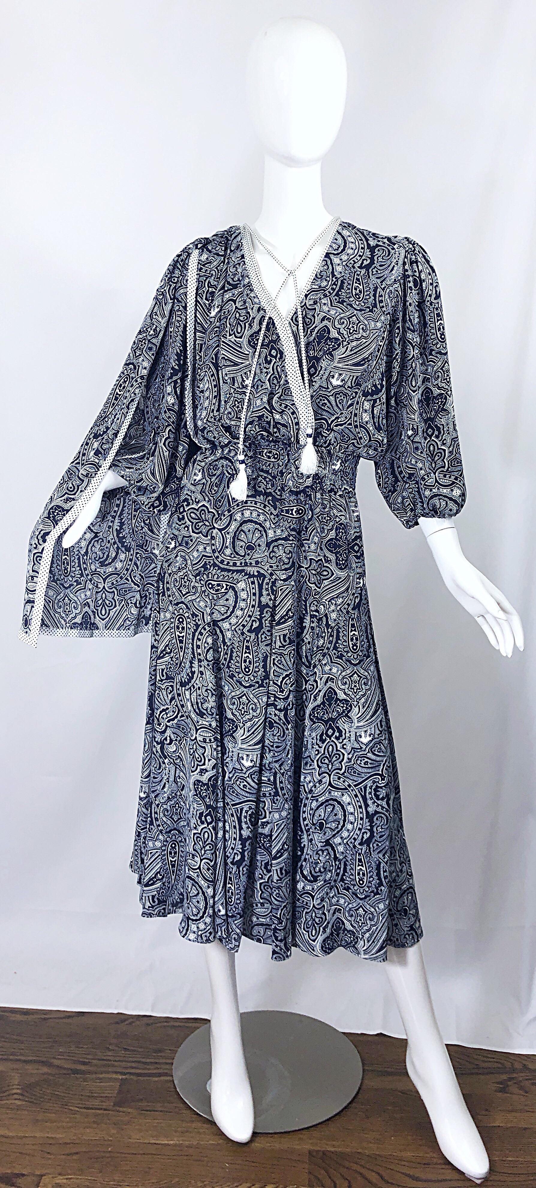 Incredible vintage DIANE FRES navy blue and white paisley bandanna print boho dress! Features an attached sash at back right side, and two tassels at the neck with beads and fringe. Elastic waistband stretches to fit most sizes. Can easily be