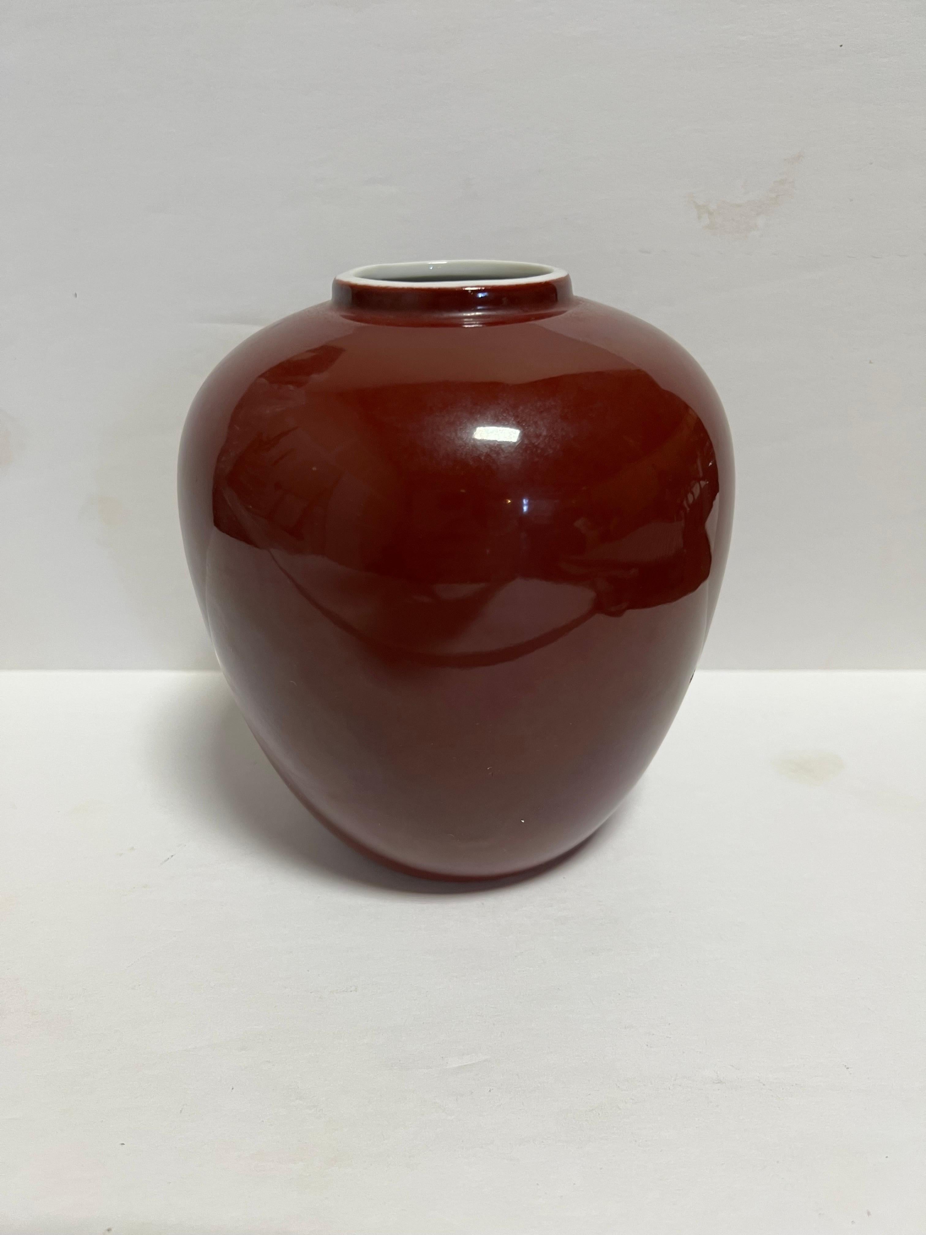 Oxblood red shoulder vase with white interior by Diane Love by Mikasa.

Signed.

Japan, circa 1980.

Dimensions: 6.25” H x 5.5” W