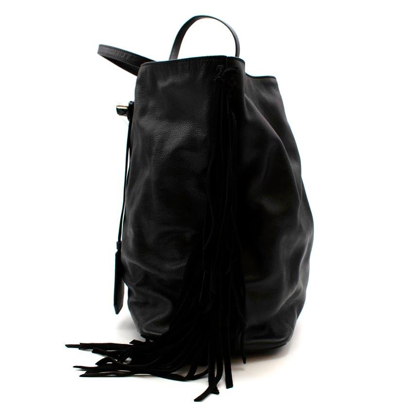 DIANE von FURSTENBERG Black Sutra Leather Fringe Bag

- Black Leather 
- Tassel Designs 
- Fringed Detail 
- Red Lining 

Fringed suede trims bring a bohemian feel to DVF's black leather Voyage East West tote this season. It's bonded with a fuchsia