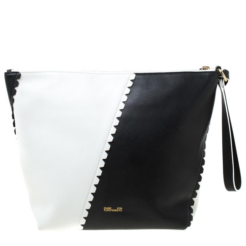 This Diane von Furstenberg creation is built to suit your stylish ensembles. Crafted from black and white leather, it has a zipper which secures a spacious fabric interior. The clutch is complete with a wristlet.

Includes: Info Booklet, Original
