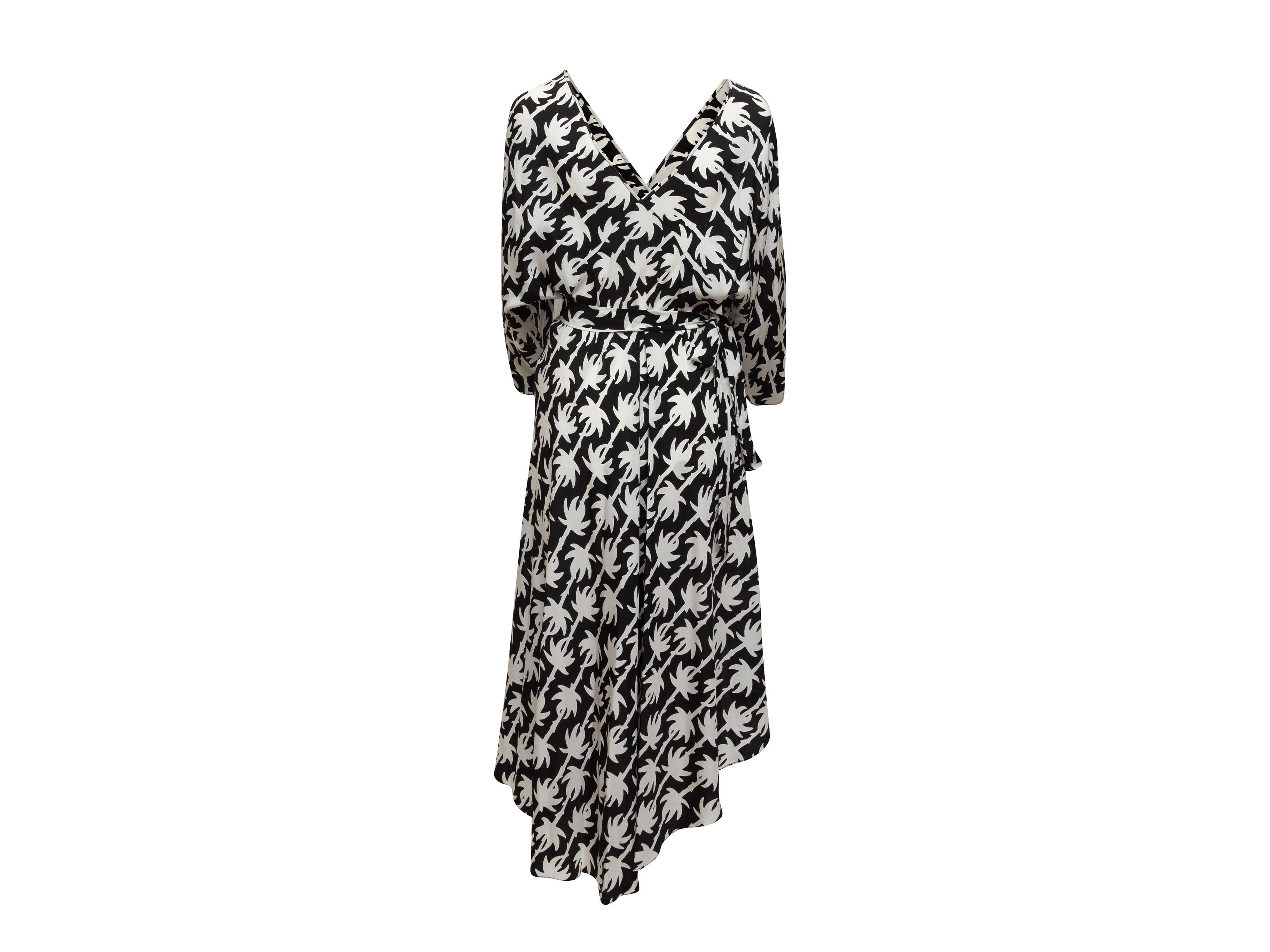 Product details: Black and white silk long sleeve wrap dress by Diane Von Furstenberg. Abstract print throughout. Surplice neckline. Asymmetrical hem. Tie closure at waist. 41