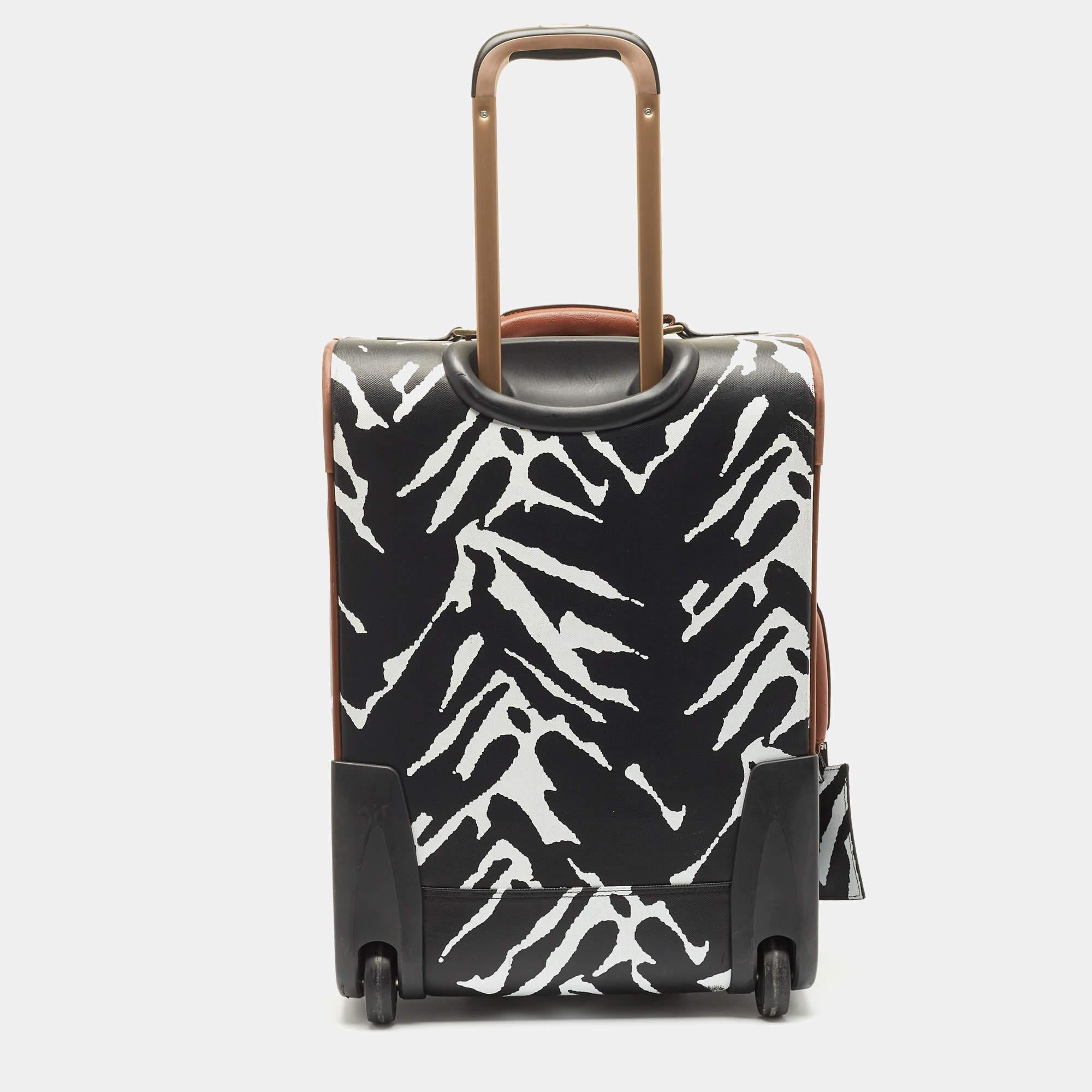 A traveling partner to trust and treasure is this one from Diane Von Furstenberg. The exterior has been crafted from zebra-print canvas while the spacious interior is lined with fabric. Equipped with handles and a telescopic handle, this luggage bag