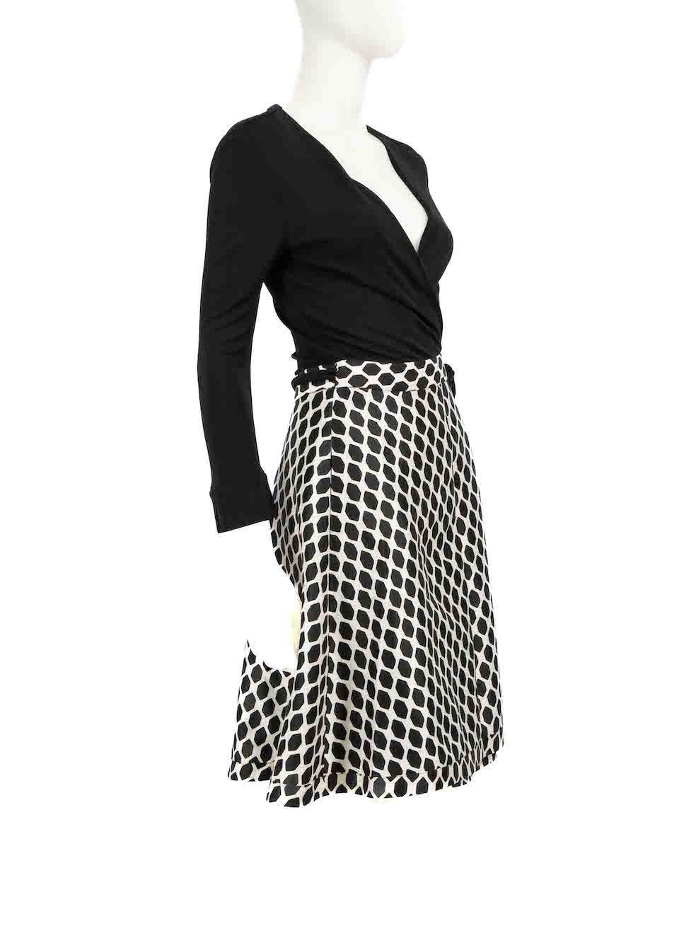 CONDITION is Very good. Minimal wear to dress is evident. Minimal pull to weave on front neckline on this used Diane Von Furstenberg designer resale item.
 
 
 
 Details
 
 
 Black
 
 Wool
 
 Wrap dress
 
 Midi
 
 Long sleeves
 
 Patterned skirt
 
