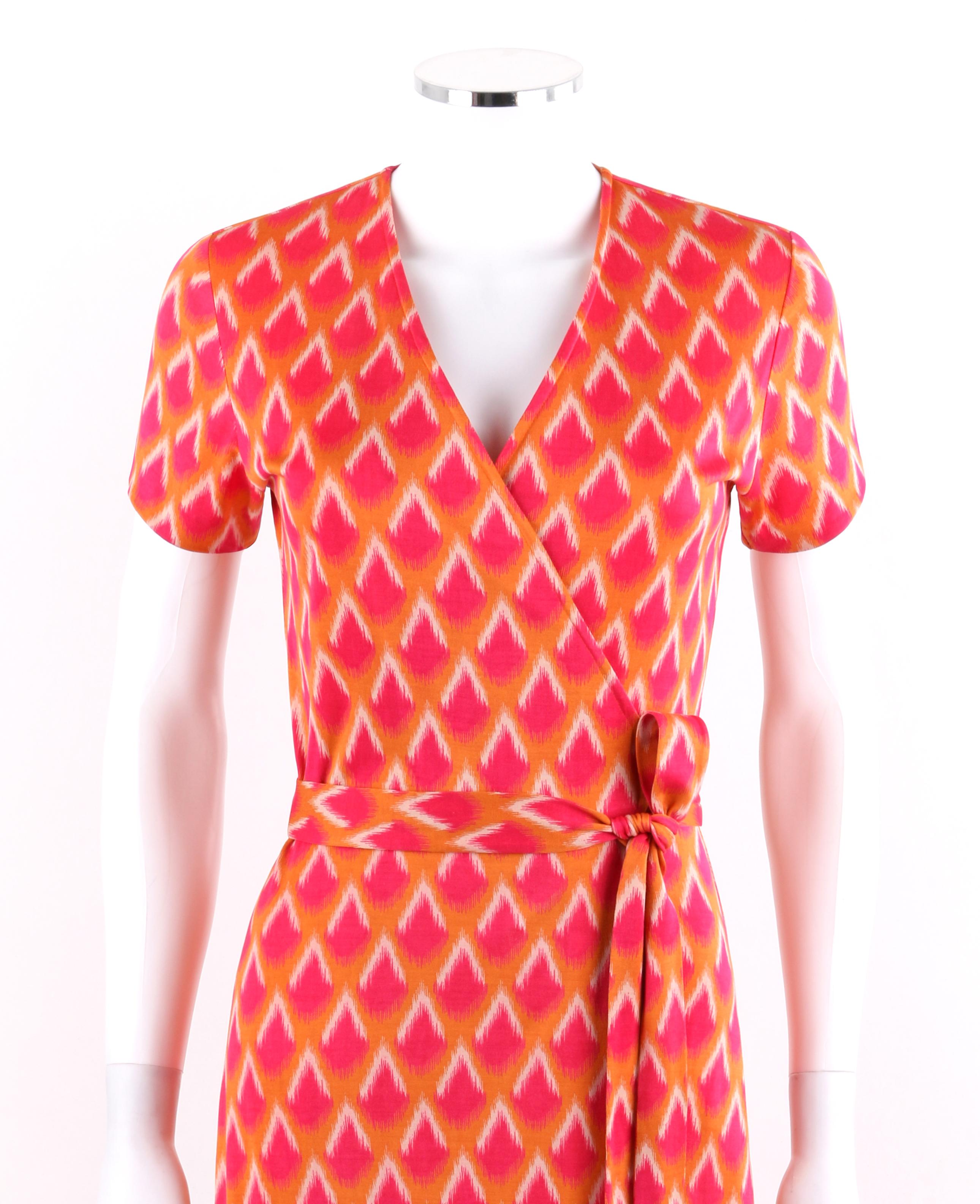 DIANE VON FURSTENBERG c.1970's DVF Abstract Print Silk Jersey Iconic Wrap Dress
 
Circa: c1970s
Label(s):  Diane Von Furstenberg / Neiman Marcus Exclusive 
Style: Wrap dress
Color(s): Shades of orange, red, and white
Lined: No
Marked Fabric Content: