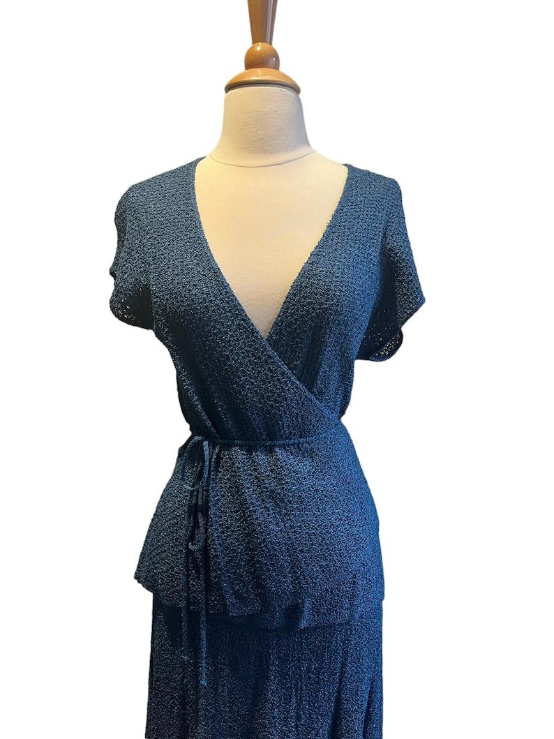 Vintage 70s does 30s two piece knit blouse & skirt set. short cap sleeves, deep v neck wrap blouse that ties at waist. knee length skirt with elastic waist. 

✩ This ensemble is an iconic designer piece of fashion history!

Circa  Late 1970s - Early