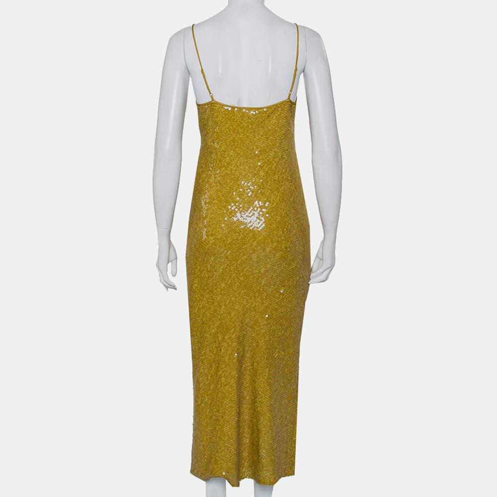 You will love the way you look when you slip this dress on. It is a creation by Diane von Furstenberg, wonderfully designed with sequin embellishments, elegantly complemented by a mid-length hemline. A pair of metallic sandals and an elegant bag