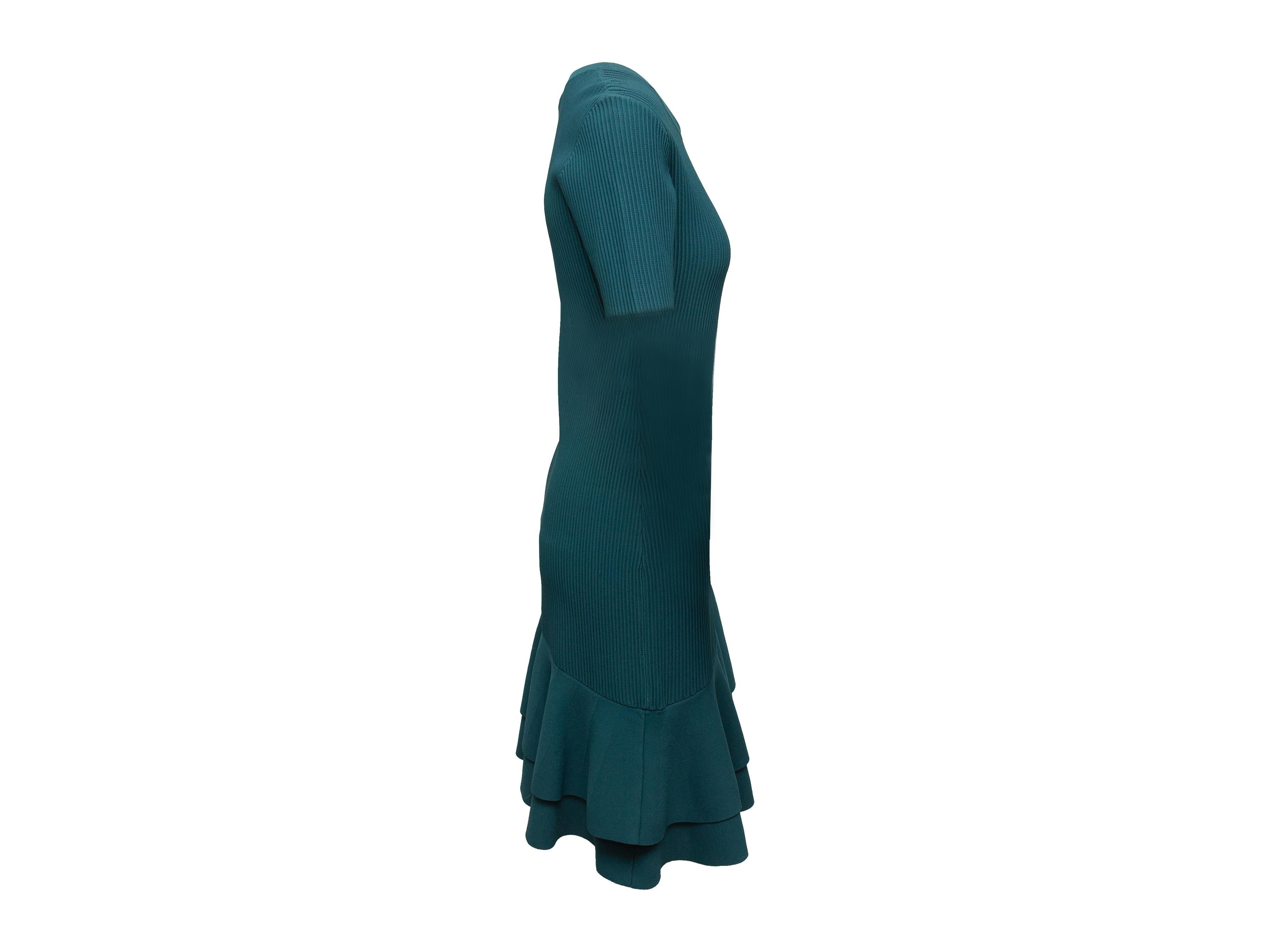 Product details: Teal rib knit dress by Diane Von Furstenberg. Crew neck. Short sleeves. Asymmetrical ruffle hem. 29