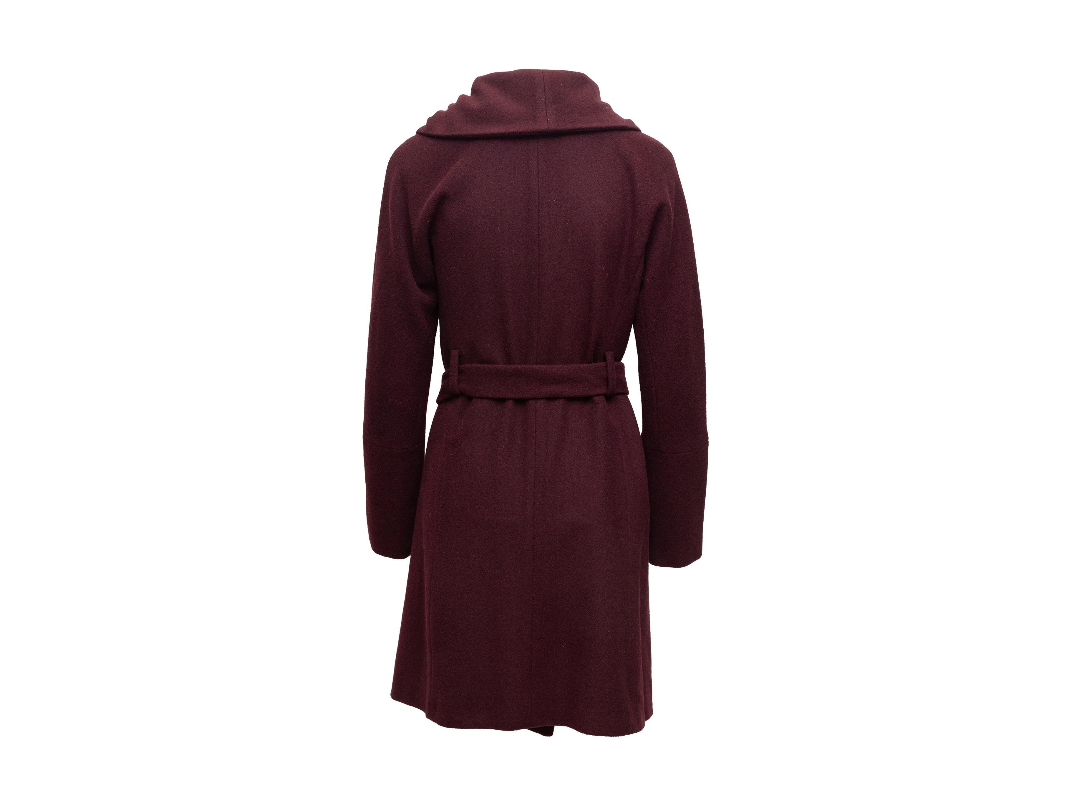Product details: Wine wool and cashmere-blend belted coat by Diane Von Furstenberg. Foldover collar. Dual slit pockets at hips. Button closurer at front. 36