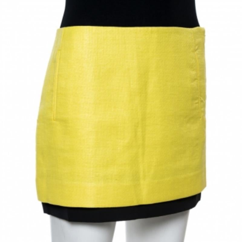 Ditch those monotonous skirts and go ahead with this vibrant yellow one from DVF! The coated raffia mini skirt has a flattering silhouette and comes equipped with two external pockets and a hook closure. It will look great with a silk blouse and