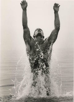 Kenny Surfacing (young nude male leaps out of sea with arms raised to the sky)