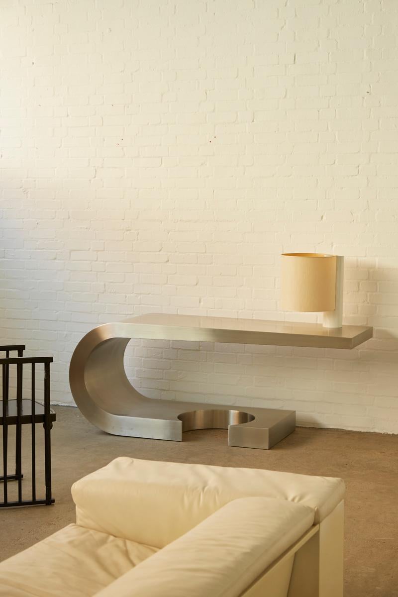 The Diapason Desk, designed by Italian architect and designer Marzio Cecchi in 1968, is a notable example of mid-20th-century furniture design. Manufactured by Studio Most in Italy, this desk is crafted entirely from brushed stainless steel, giving
