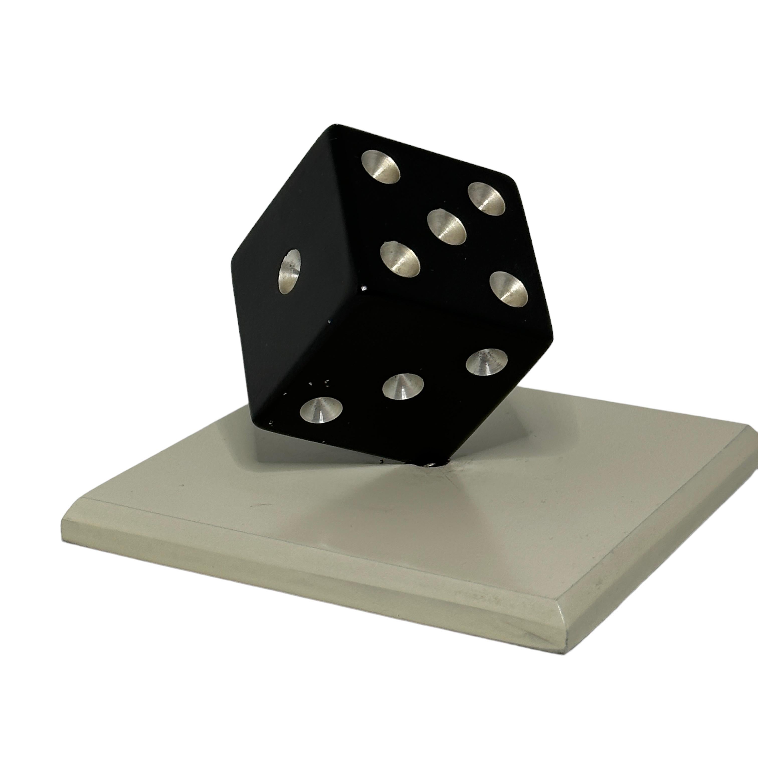 A german vintage aluminum paperweight or sculpture featuring a dice balanced on one corner. Art Deco style, inspired by the 1930s designs of Edgar Brandt. A minimalist dice sculpture which would grace any desk.
On the upper side of the dice are the