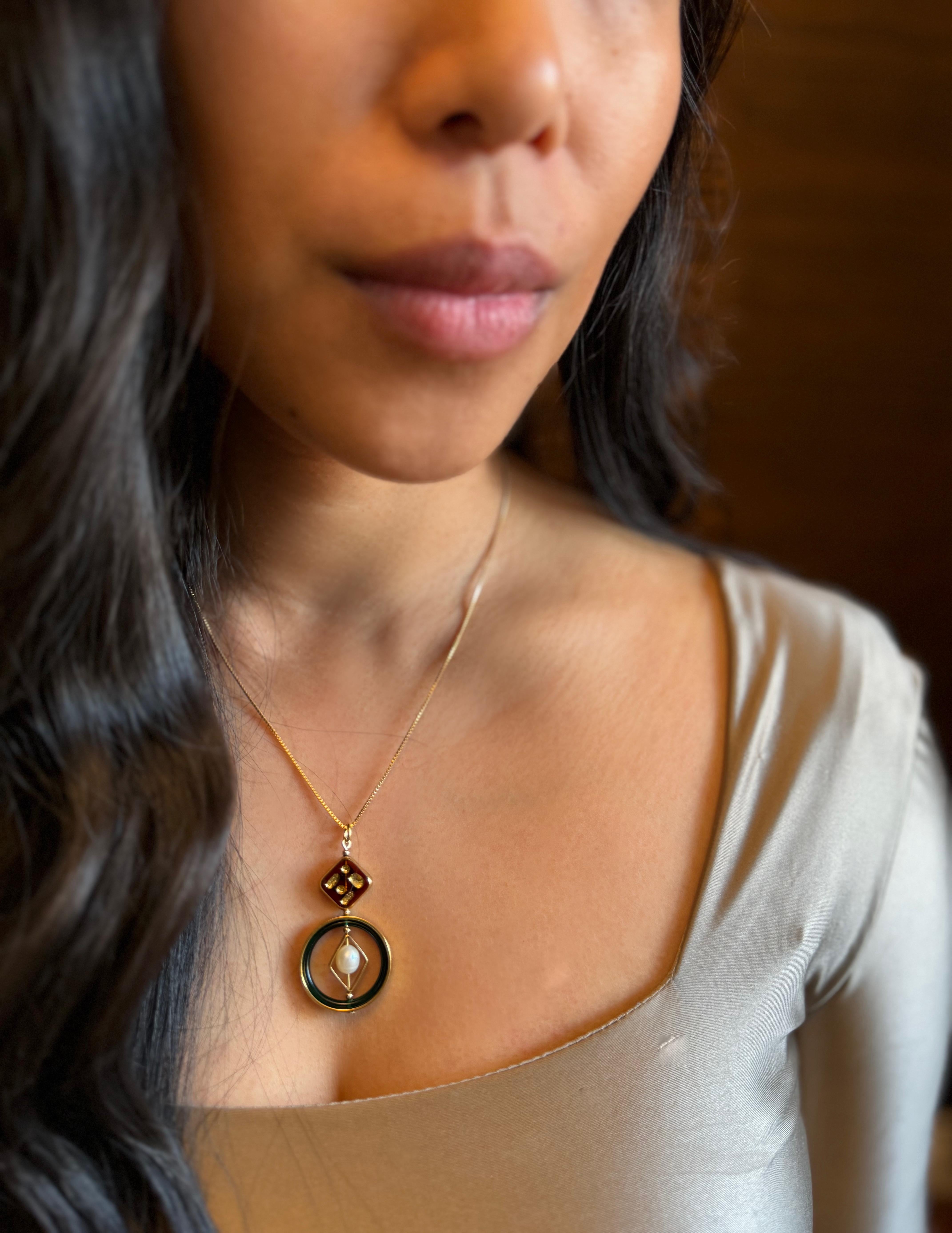 Brown vintage German glass beads edged with gold, vintage lucite, freshwater pearls, brass metal plated with 24K gold, 18 inches gold-filled chain and findings.

The vintage German glass beads were hand-pressed during the 1920s- 1960s. They are no
