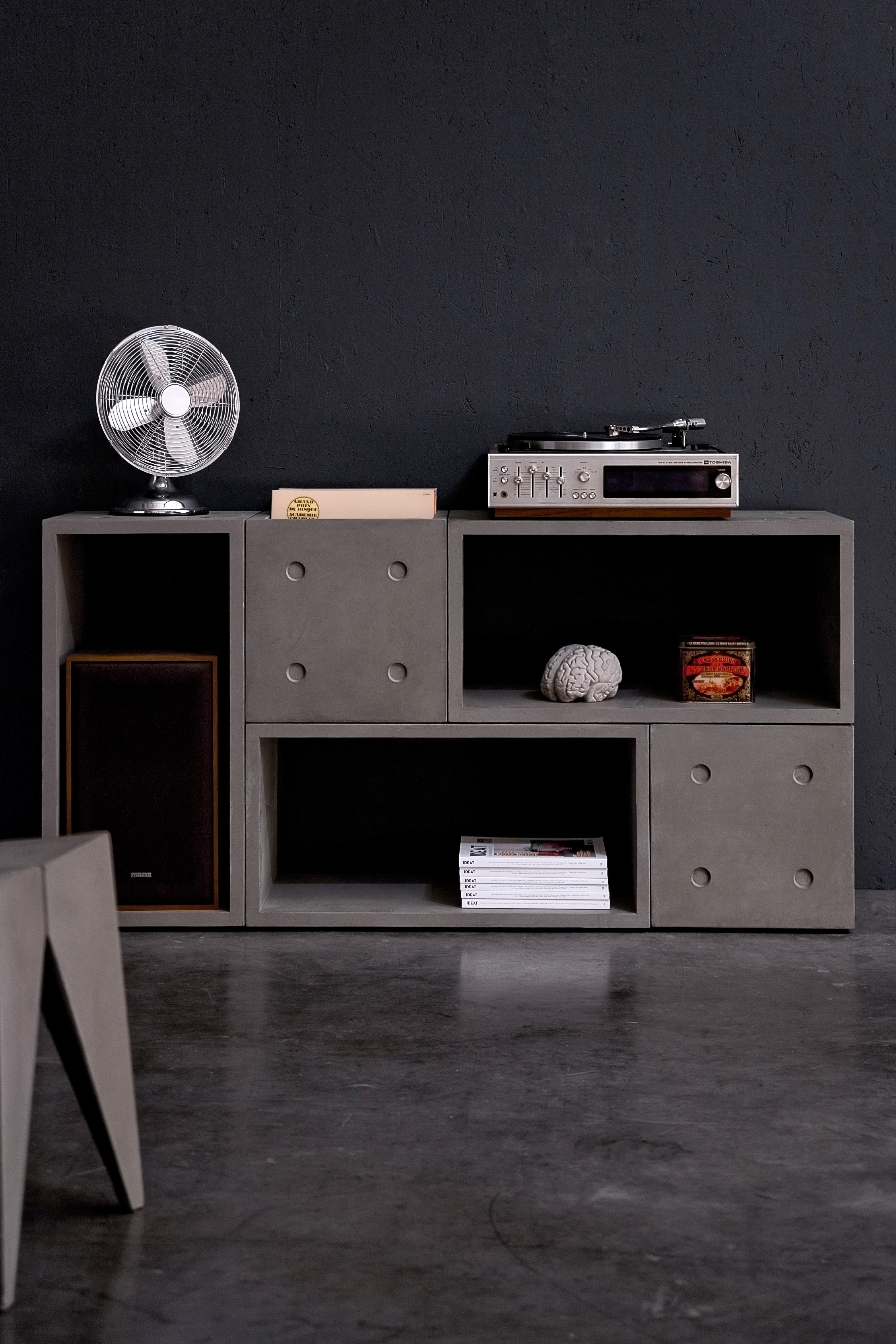 With 2 small and 3 large dice concrete cubes you can build serious furniture.
a hifi unit to place your record player and store a bunch of vynil records (about a hundred in each small cubes, 200 in the large one), a bookshelf for your kids, a