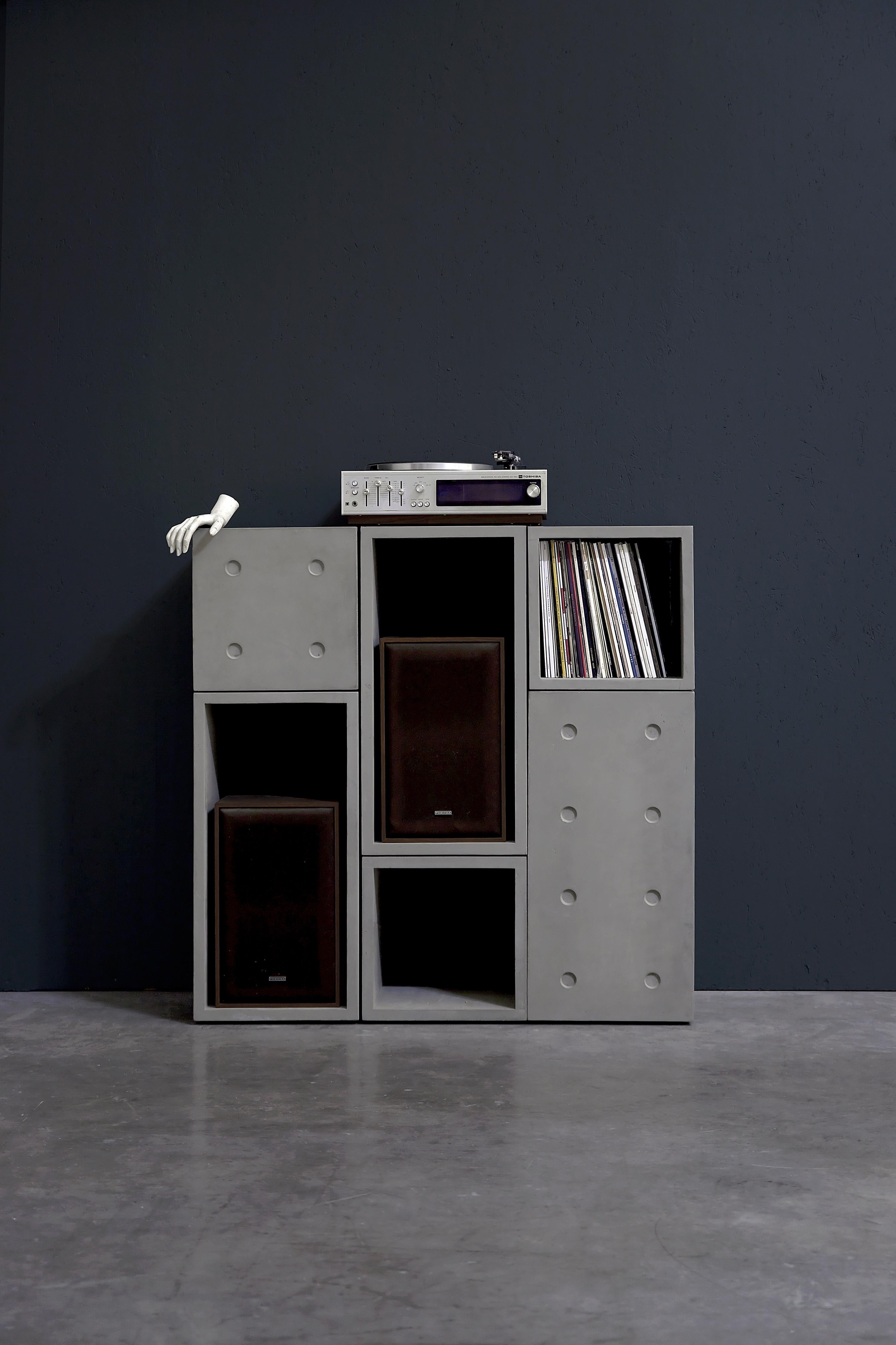 With 3 small and 3 large dice concrete cubes you can build serious furniture.
a hifi unit to place your record player and store a bunch of vynil records (about a hundred in each small cubes, 200 in the large one), a bookshelf for your kids, a