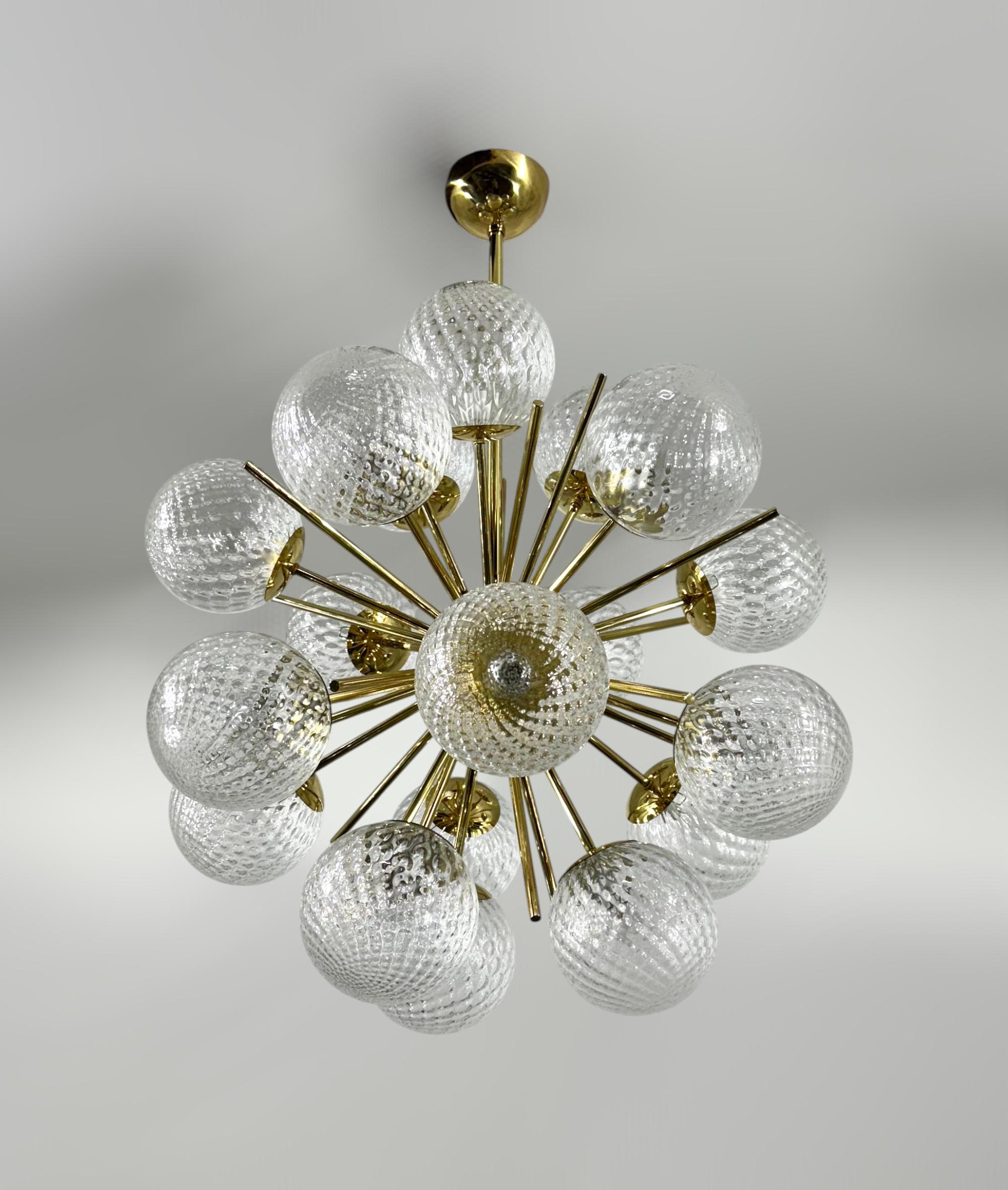 Italian sputnik chandelier with 18 textured balloton Murano glass globes mounted on brass frame / Designed by Fabio Bergomi for Fabio Ltd / Made in Italy
18 lights / E12 or E14 type / max 40W each
Diameter: 29 inches / Height: 36 inches including
