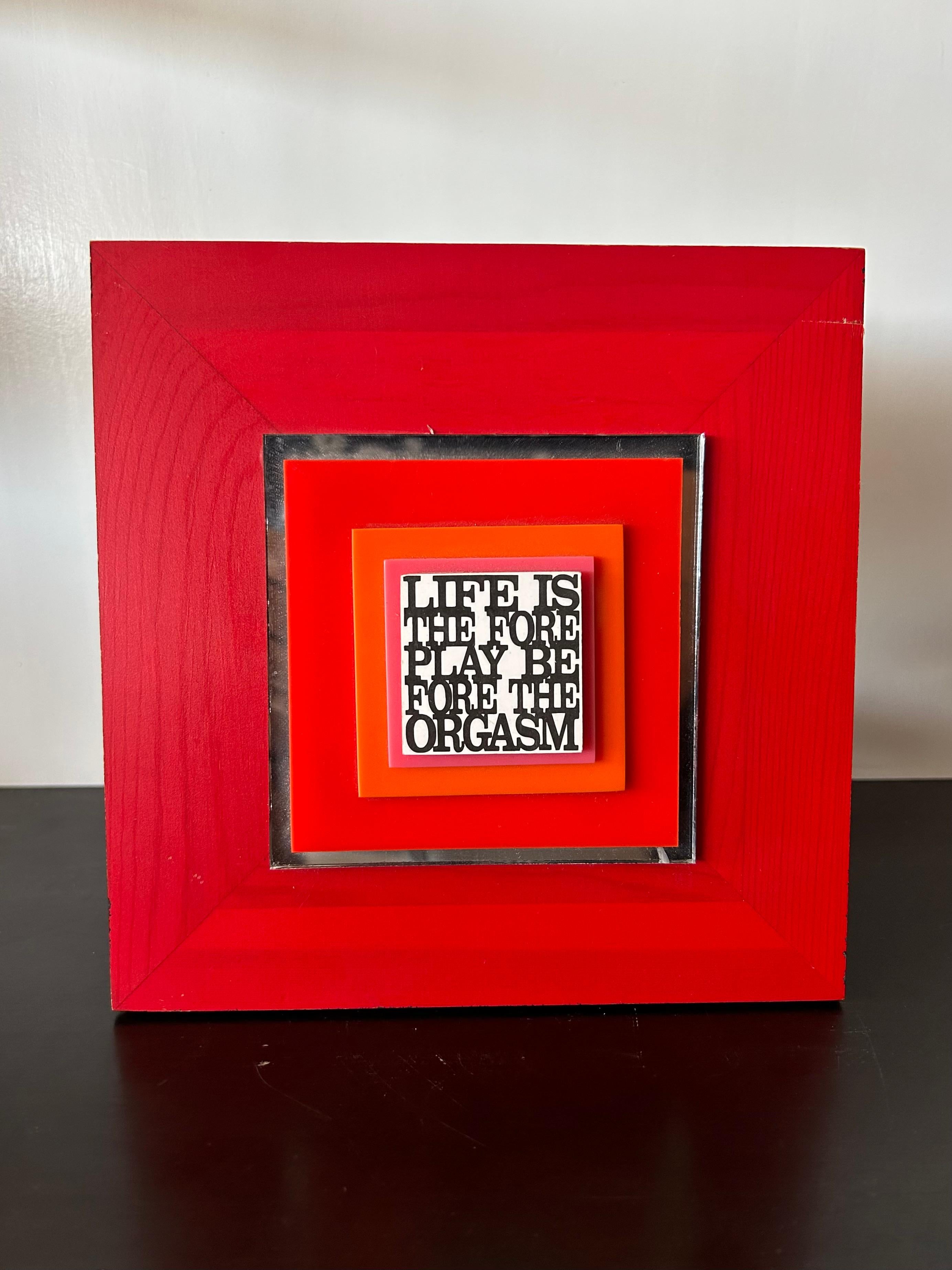 Square red painted wood, lucite and mirrored artwork by Arizona artist Dick Seeger with saying, 