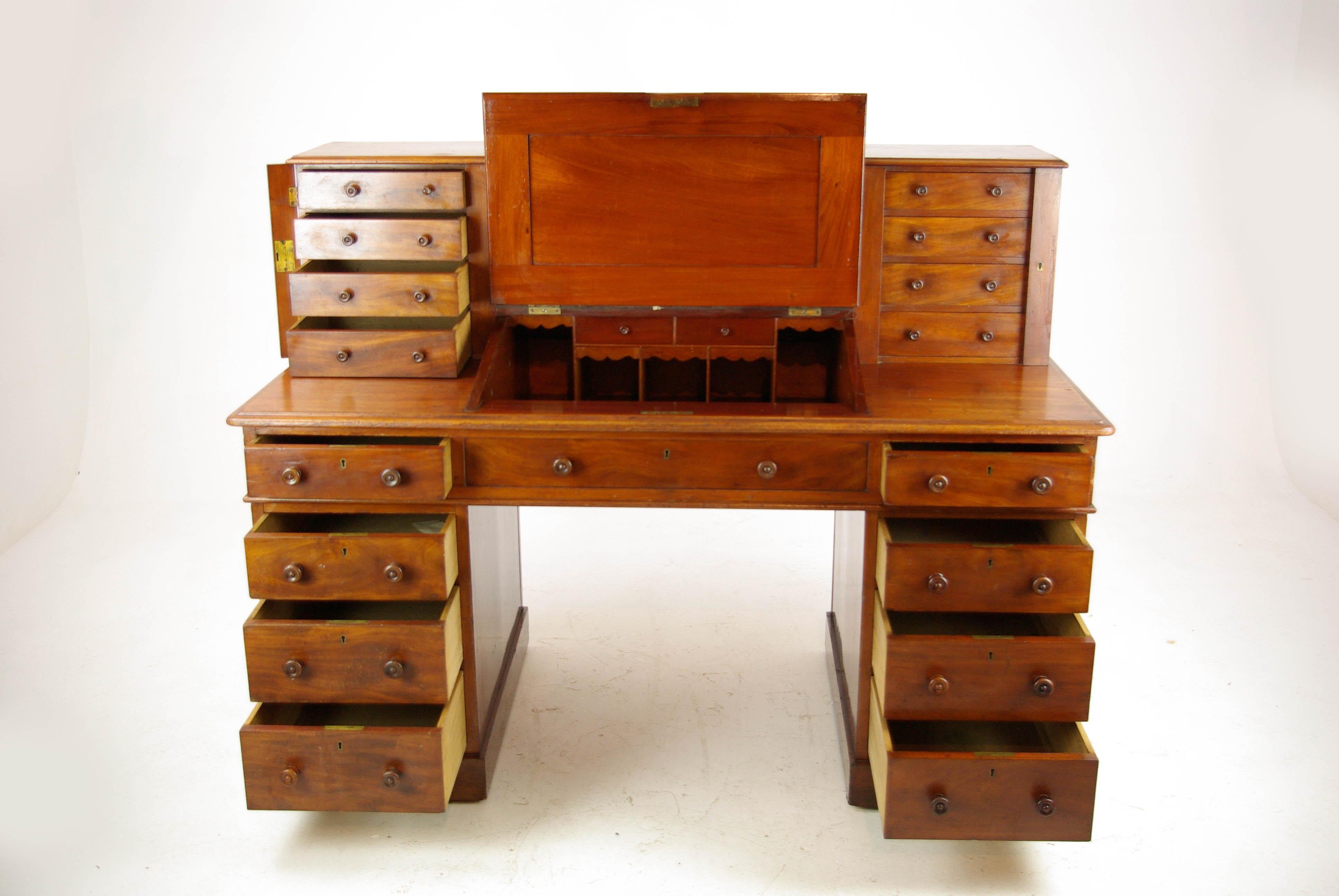 Dickens desk, antique walnut desk, slant front desk, England 1880, antique furniture, B1241

England 1875
Solid walnut
Original finish
Topped with central spindled gallery
Flanked by two flights of four small drawers
Secured with locking bars
Center
