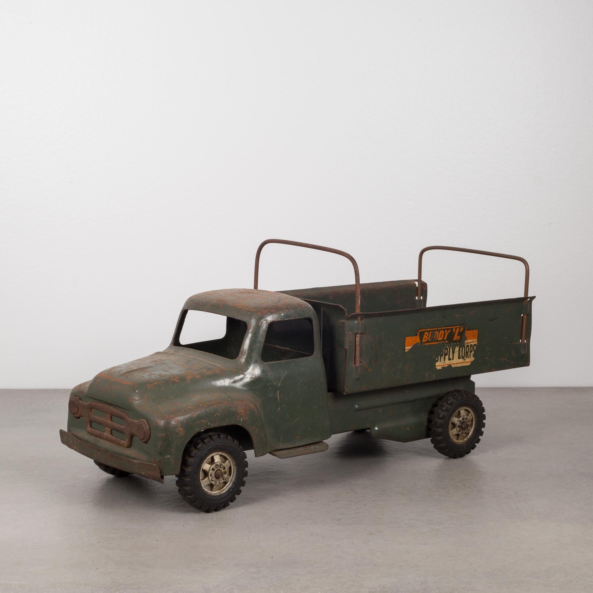 About

This is an original die cast steel toy truck with rubber wheels, finished in army-green powder coating by the Buddy L Corporation. The truck has advertising on both sides that reads 