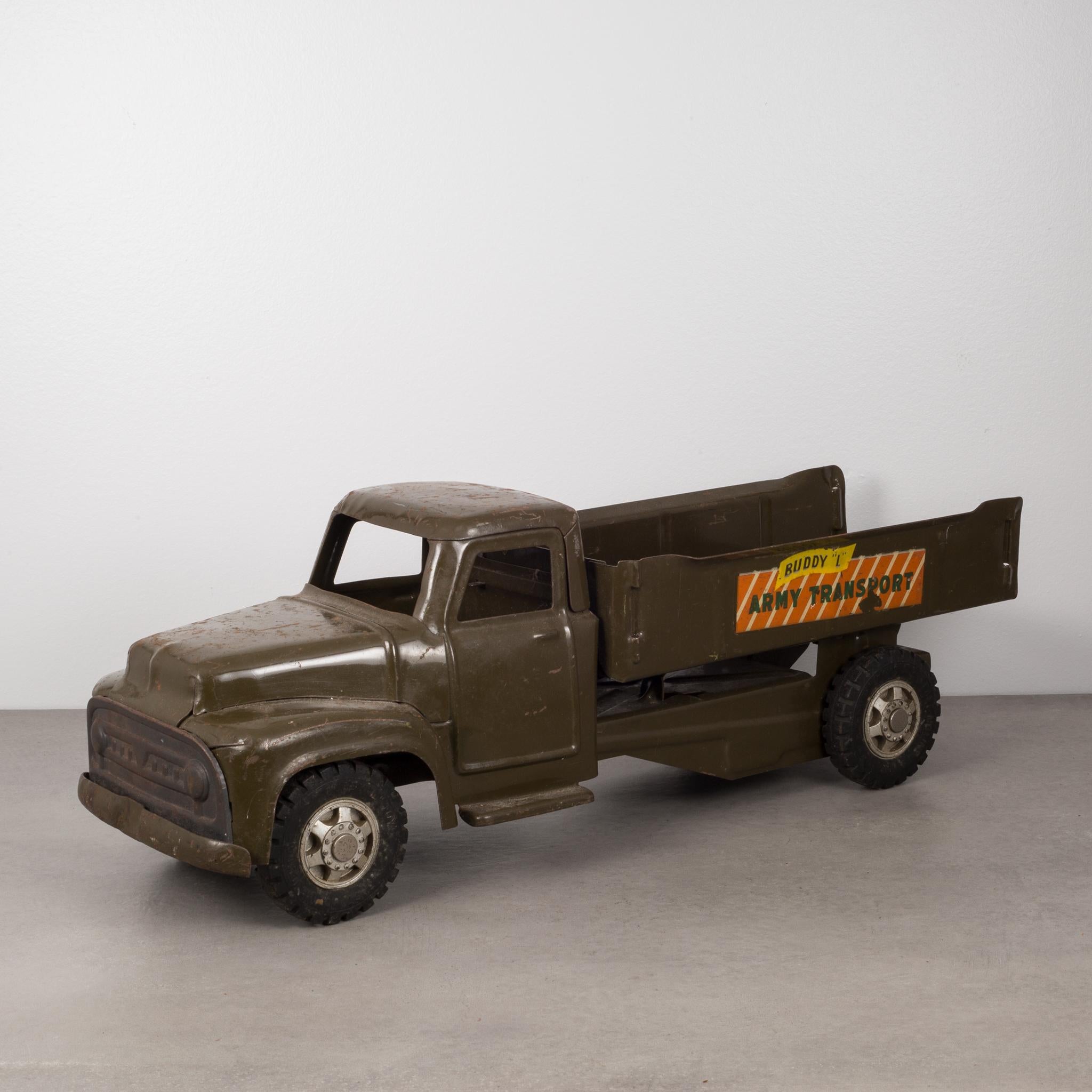 About

This is an original die cast steel toy truck with rubber wheels, finished in army-green powder coating by the Buddy L Corporation. The truck has advertising on both sides that reads 