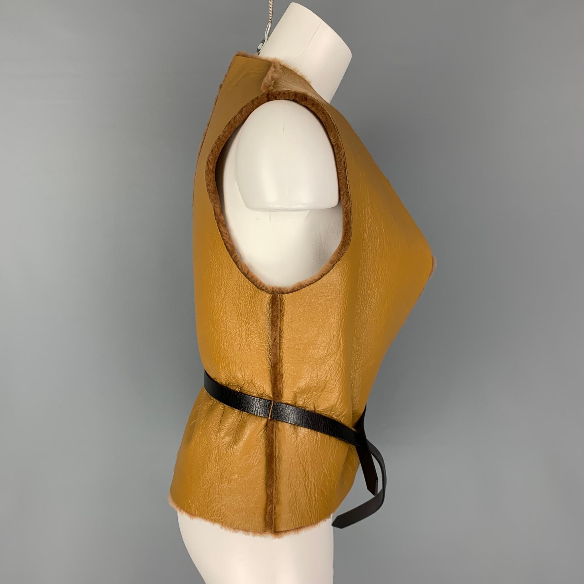 DIEGO BINETTI vest comes in a tan sheep skin leather with a faux fur lining featuring a open front and a belted style. 

New With Tags. 
Marked: M 

Measurements:

Shoulder: 14 in.
Bust: 36 in.
Length: 22.5 in. 