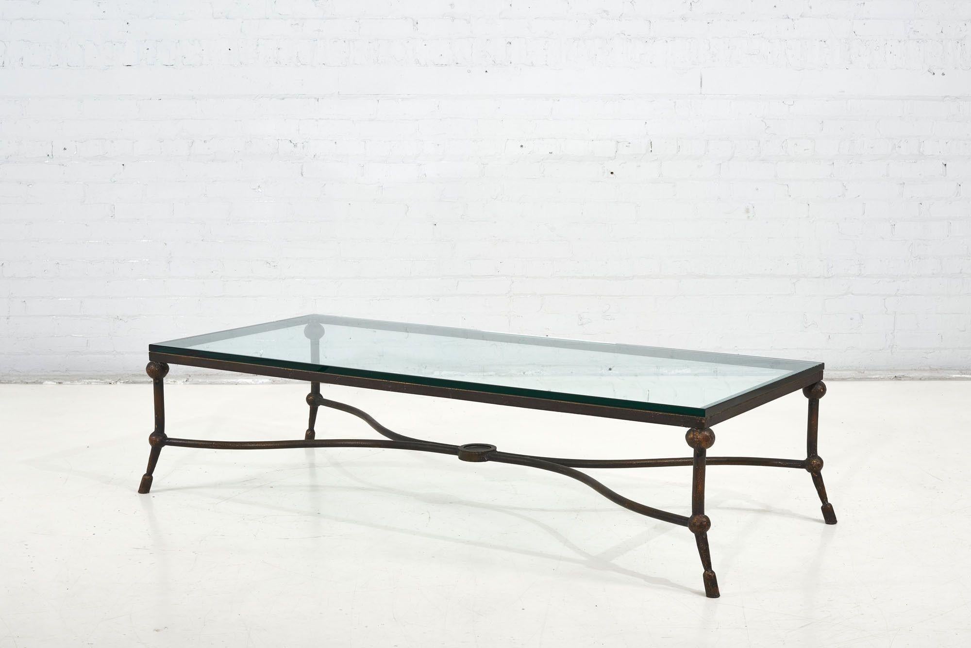 Diego Giacometti style coffee table. Bronze color finish over metal with glass top.