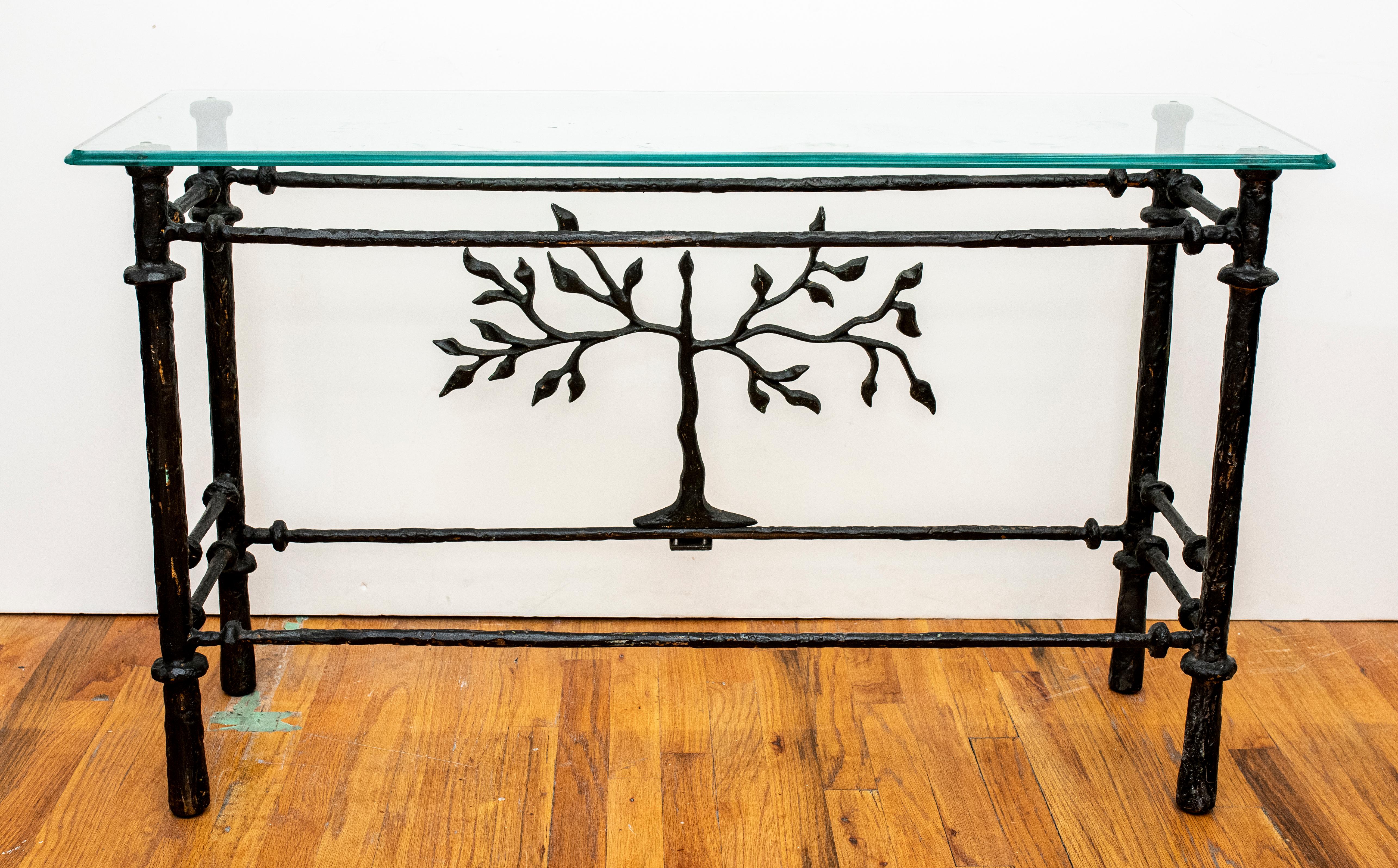 Diego Giacometti Style modern cast metal console table with tree motif at the back side and glass top. Measures: 27.5