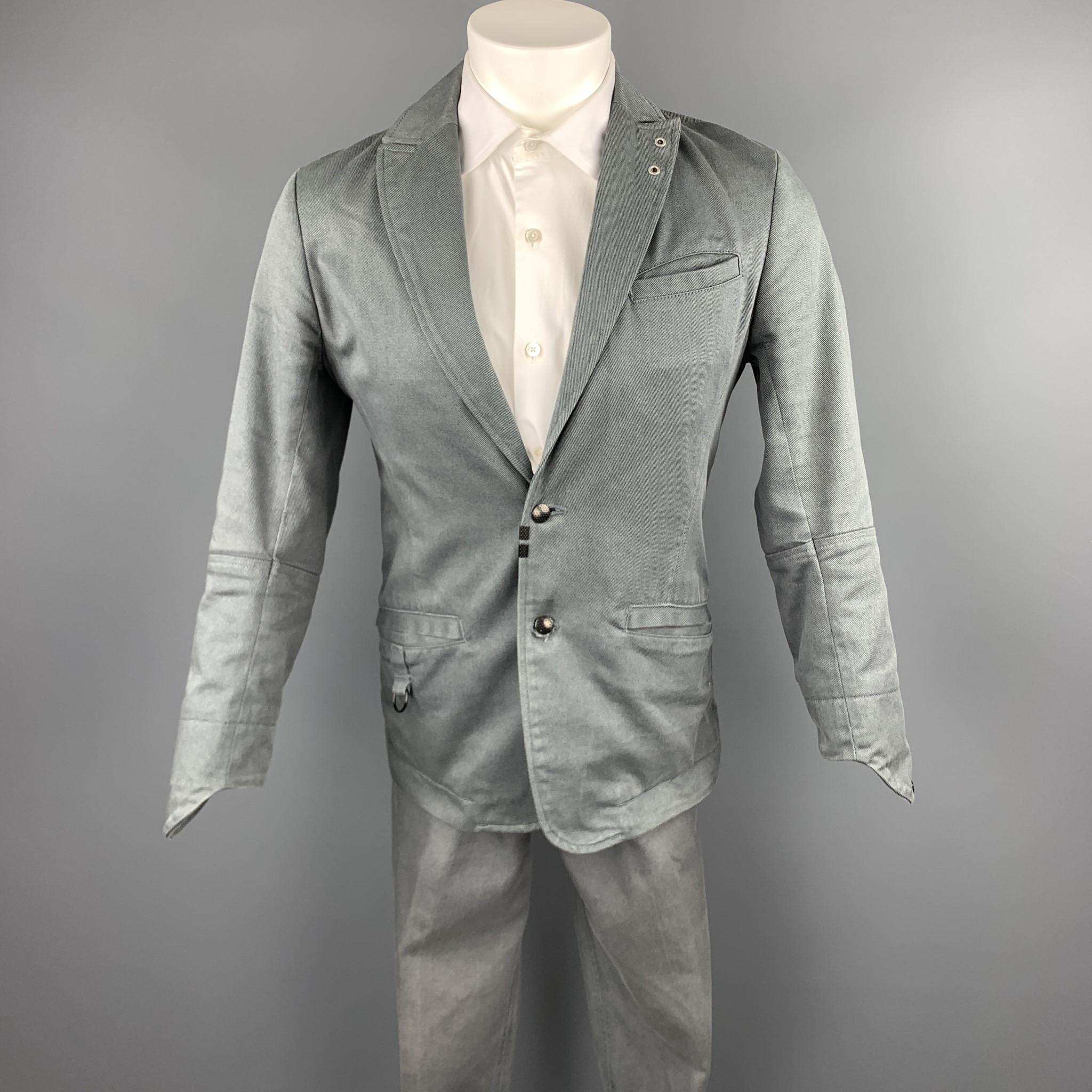 DIESEL suit comes in a gray cotton blend and includes a single breasted, two button sport coat with a peak lapel and matching flat front trousers. 

Excellent Pre-Owned Condition.
Marked: S

Measurements:

-Jacket
Shoulder: 16 in. 
Chest: 38 in.