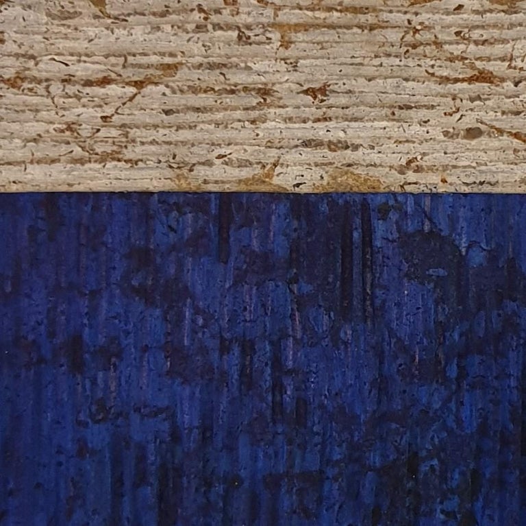 o.T. (BN15HV) is a unique small size contemporary modern wall sculpture painting relief by German artist Dieter Kränzlein. The relief is made from limestone and it is partially finished with a thin layer of blue ink that has penetrated into the