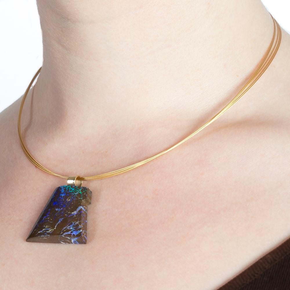 A stunning Boulder Opal pendant, carved by renowned stone carver Dieter Lorenz. 

Simply set in 14 Karat Yellow Gold it is fitted to a 14 Karat 5 strand collar necklace. 

Boulder Opal is a unique and beautiful type of Opal found only in Queensland,