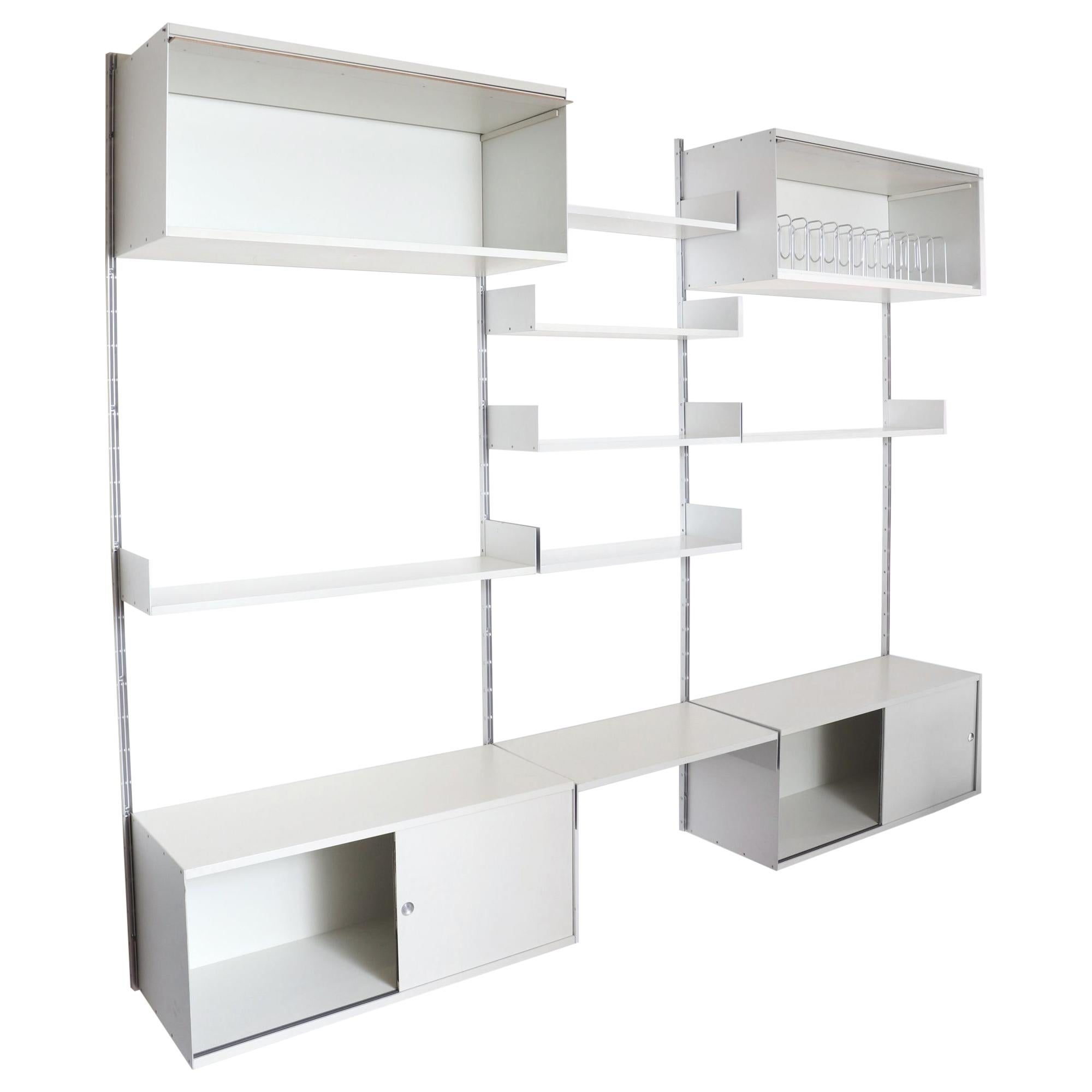 Rare 3 section Dieter Rams industrial shelving unit on aluminum risers with storage cabinets and adjustable shelves. Two lift-up and two sliding door formica cabinets with 6 adjustable formica shelves add ample storage while removable filing shelves