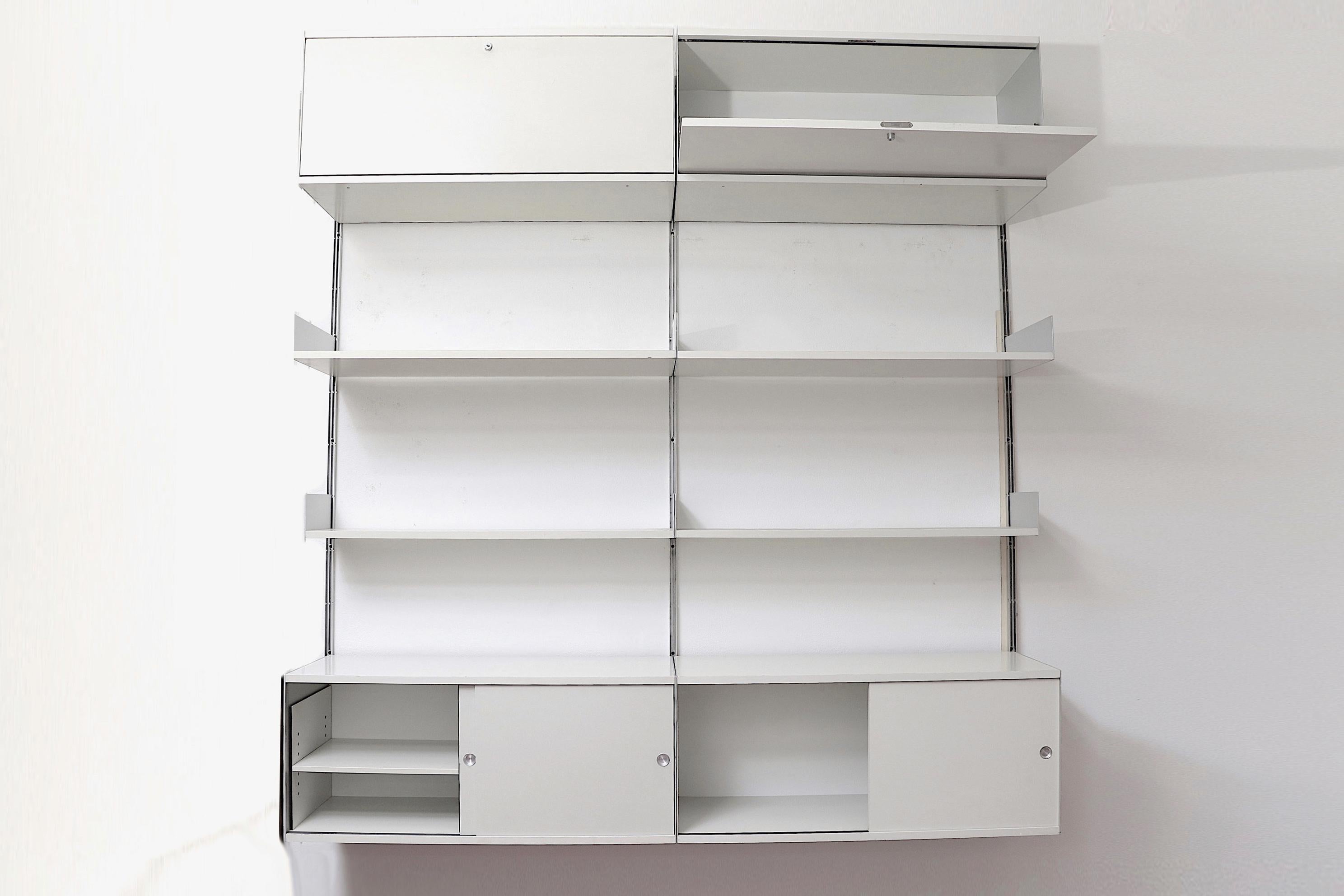 Handsome 2-section dieter rams industrial shelving unit on aluminum risers with storage cabinets and adjustable shelves. 2 lower drop-down formica cabinets with keys and 6 adjustable formica. In original condition with visible wear some chipping and