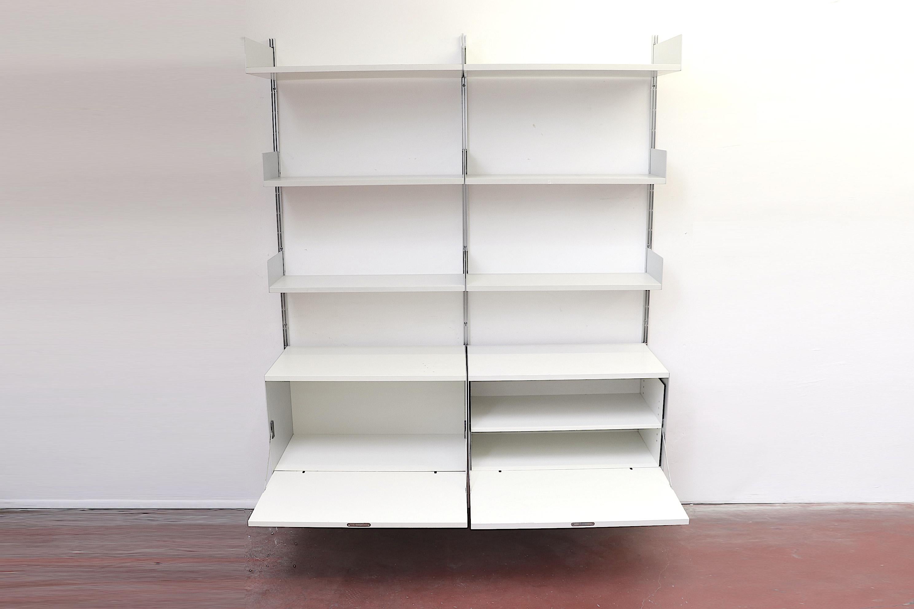 Beautiful 2-section dieter rams industrial shelving unit on aluminum risers with storage cabinets and adjustable shelves. 2 upper drop-down Formica cabinets with keys and 4 adjustable Formica shelves. In original condition with visible wear with