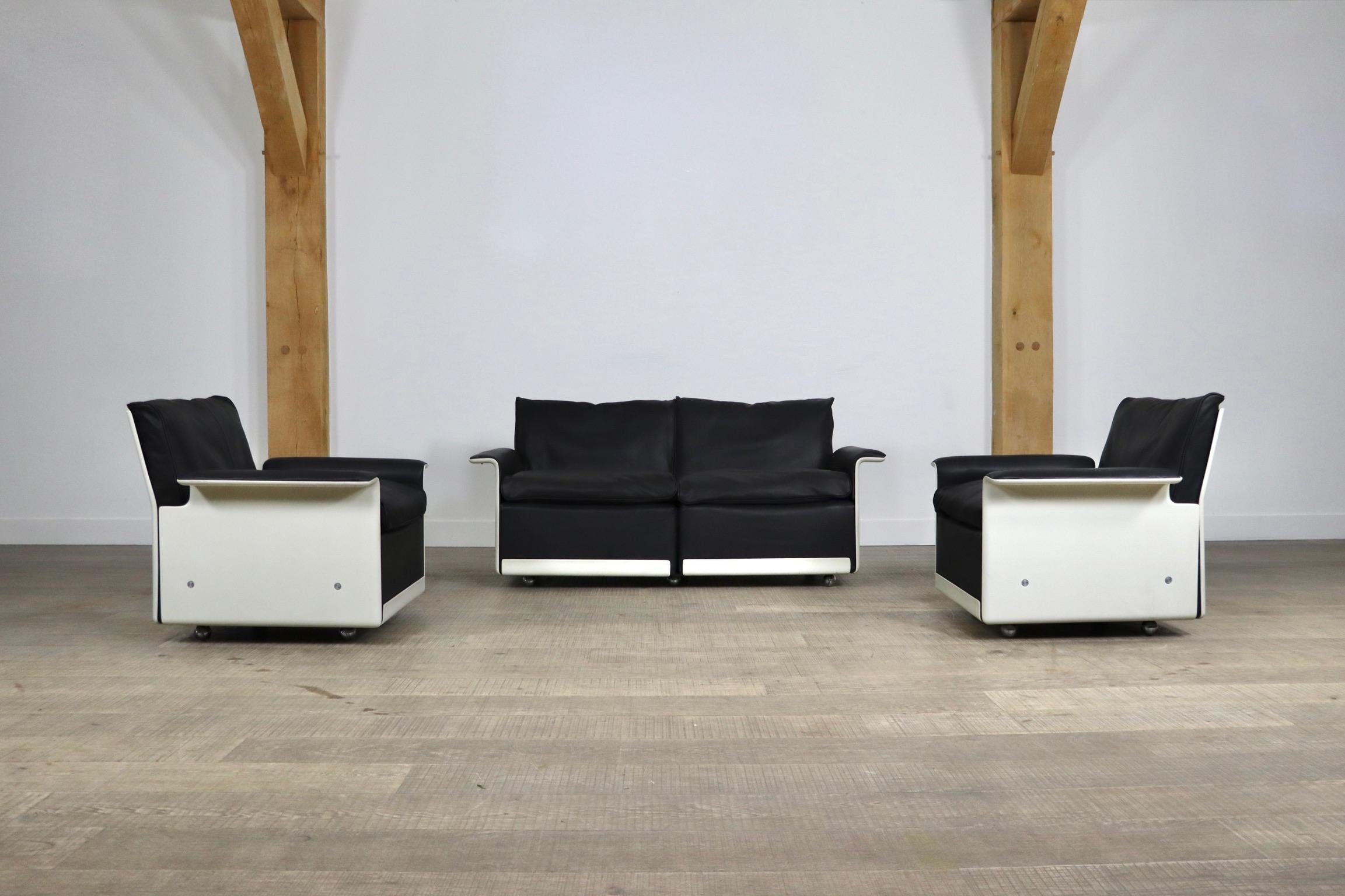 Amazing set of model 620 lounge chairs and sofa in black leather and white frames, designed by Dieter Rams in 1962 for German manufacturer Vitsœ. The shells are made of A hot-pressed sheet moulding compound that sits on four chromed wheels. This