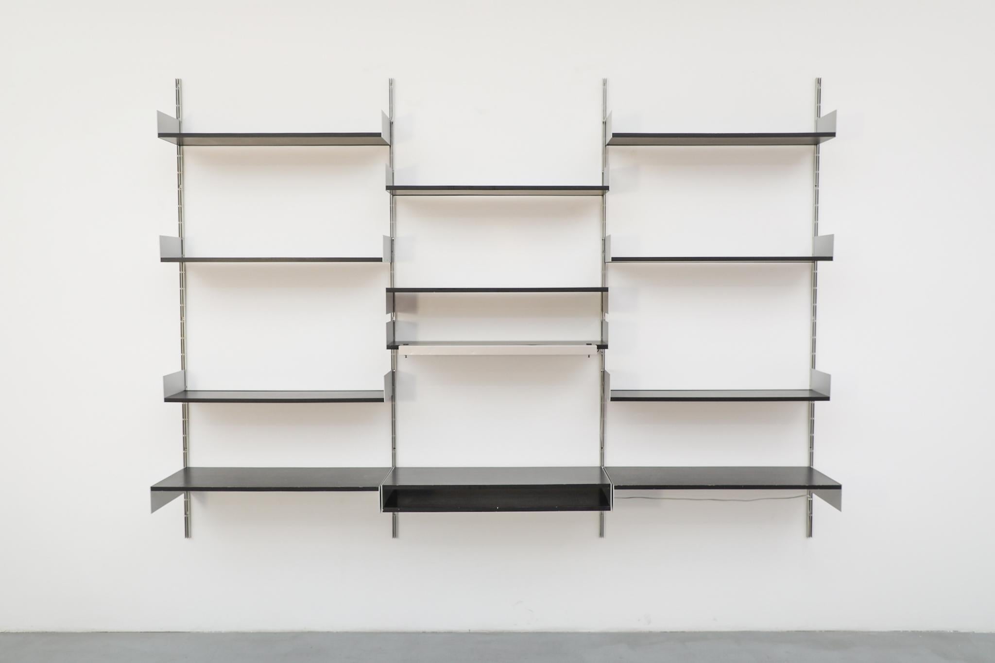 A large, wall-mounted '606' shelving system by visionary German designer Dieter Rams for Vitsoe. This legendary system is known for its timeless minimalism and flawless functionality, a defining piece of Mid-Century German design.

The modular unit